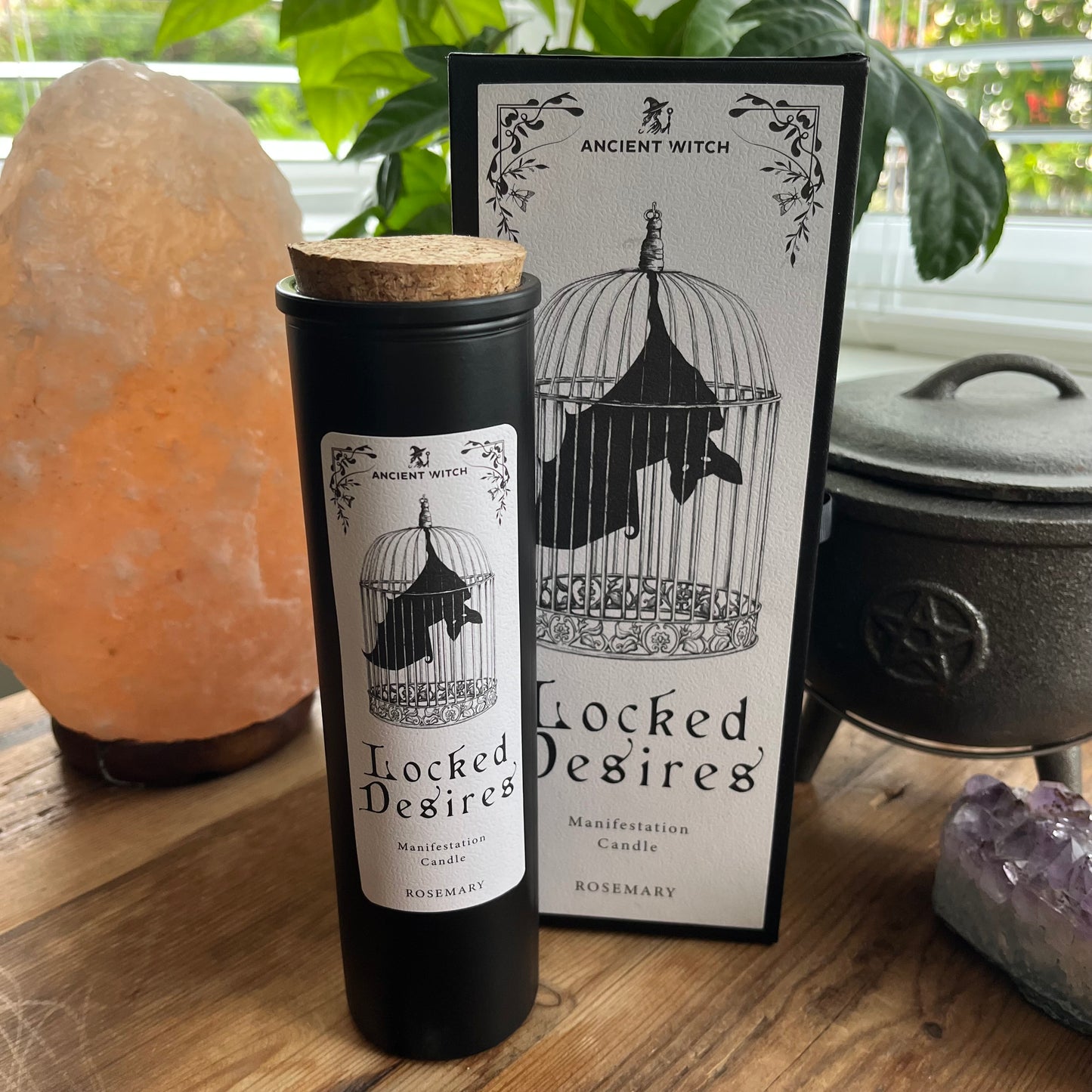 Ancient Witch Locked Desires candle in a beautifully illustrated gift box, illustrated with a Bat in a cage representing suppressed dreams, inner power and courage. Each Glass pillar candle has a cork lid. Includes a ritual spell card.