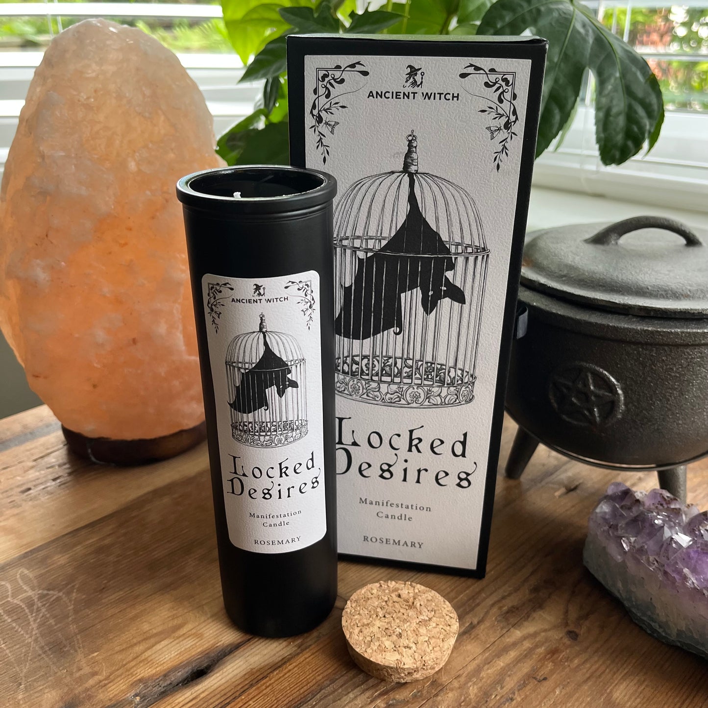 Ancient Witch Locked Desires candle in a beautifully illustrated gift box, illustrated with a Bat in a cage representing suppressed dreams, inner power and courage. Each Glass pillar candle has a cork lid. Includes a ritual spell card.