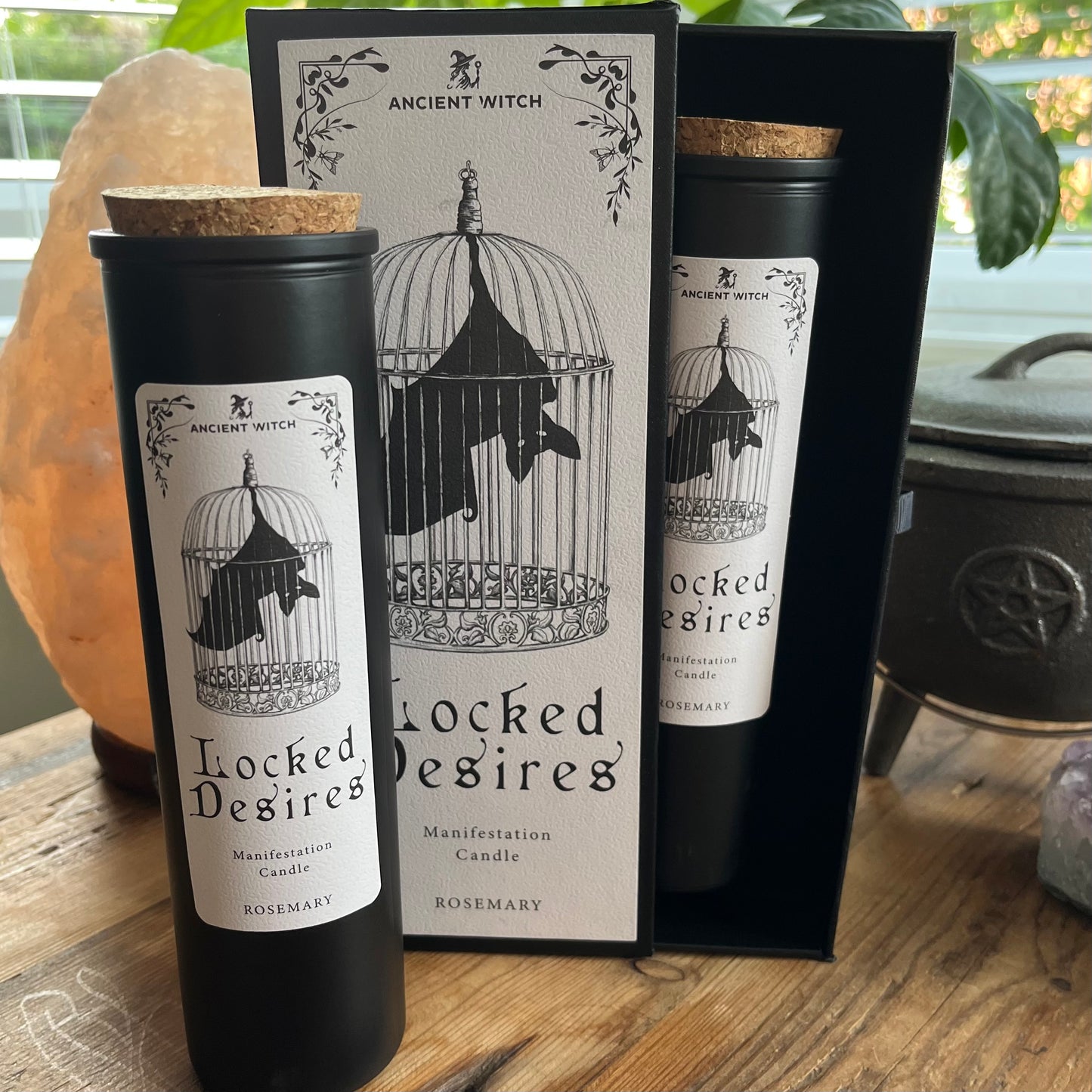 Ancient Witch Locked Desires candle in a beautifully illustrated gift box, illustrated with a Bat in a cage representing suppressed dreams, inner power and courage. Each Glass pillar candle has a cork lid. Includes a ritual spell card.