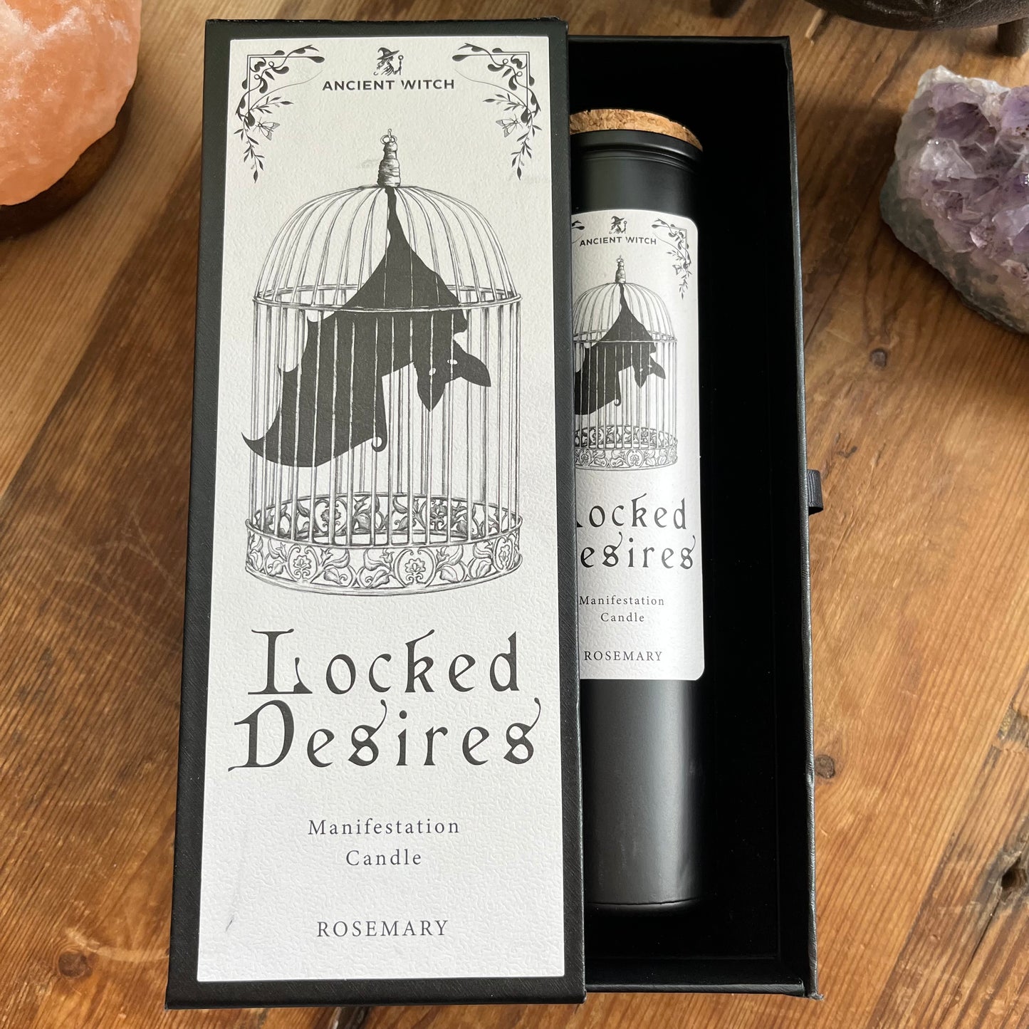 Ancient Witch Locked Desires candle in a beautifully illustrated gift box, illustrated with a Bat in a cage representing suppressed dreams, inner power and courage. Each Glass pillar candle has a cork lid. Includes a ritual spell card.