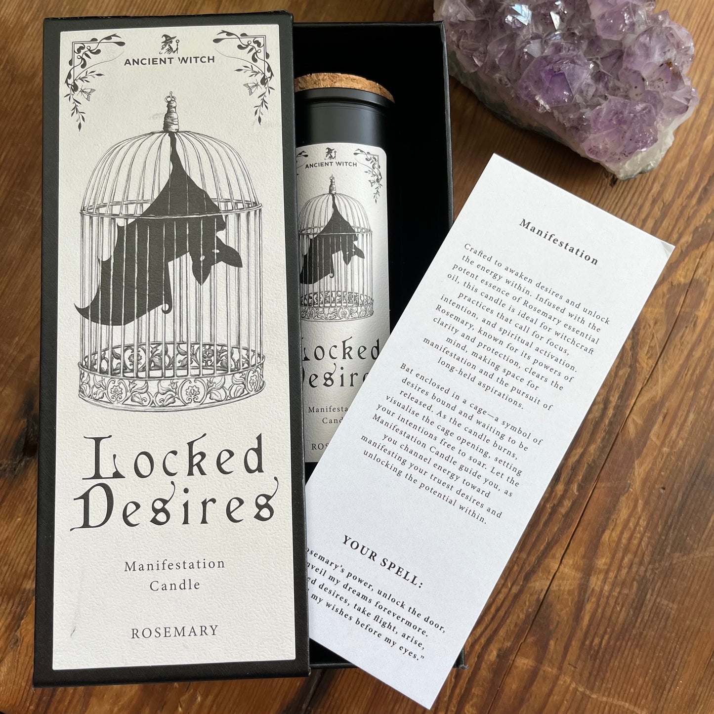 Ancient Witch Locked Desires candle in a beautifully illustrated gift box, illustrated with a Bat in a cage representing suppressed dreams, inner power and courage. Each Glass pillar candle has a cork lid. Includes a ritual spell card.