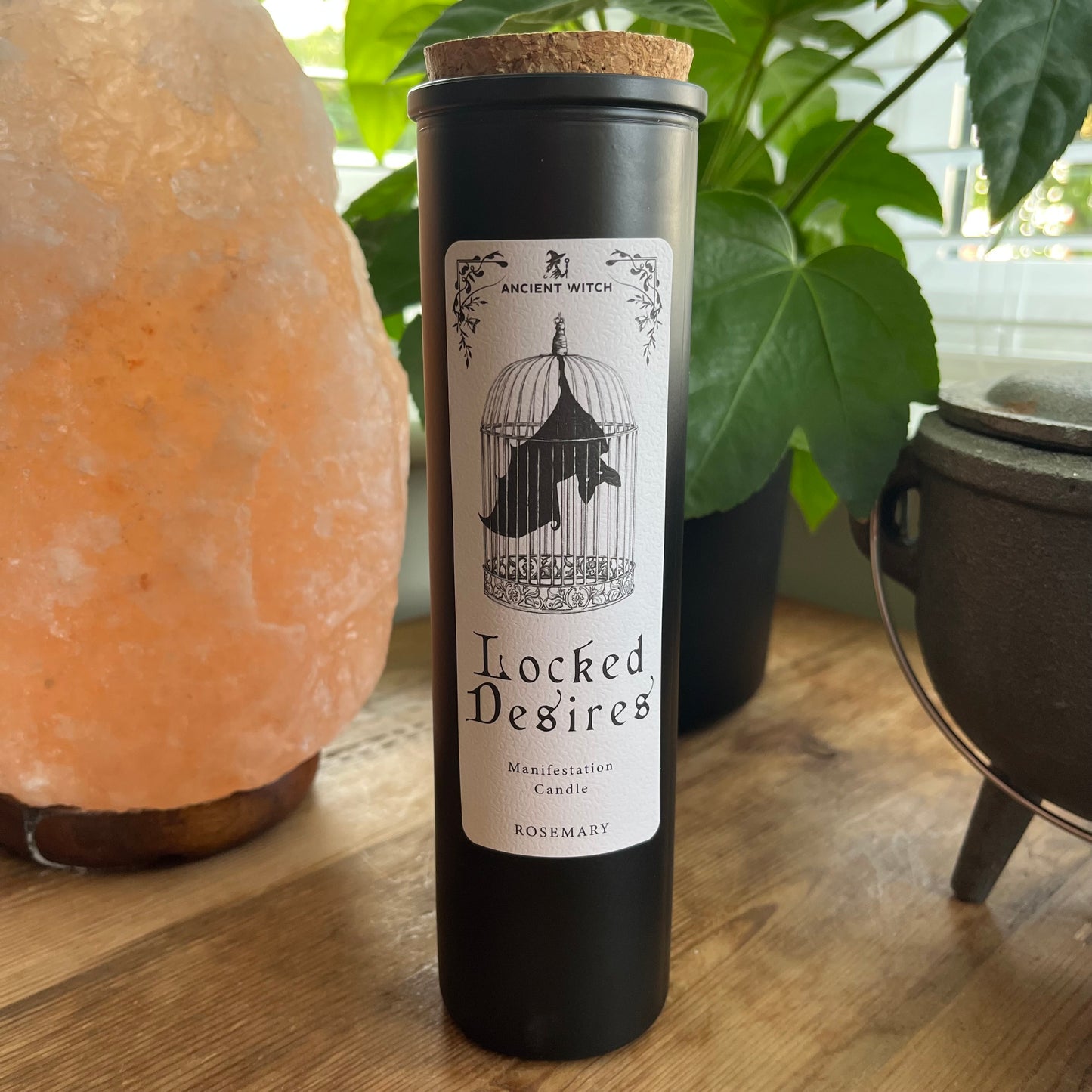 Ancient Witch Locked Desires candle in a beautifully illustrated gift box, illustrated with a Bat in a cage representing suppressed dreams, inner power and courage. Each Glass pillar candle has a cork lid. Includes a ritual spell card.