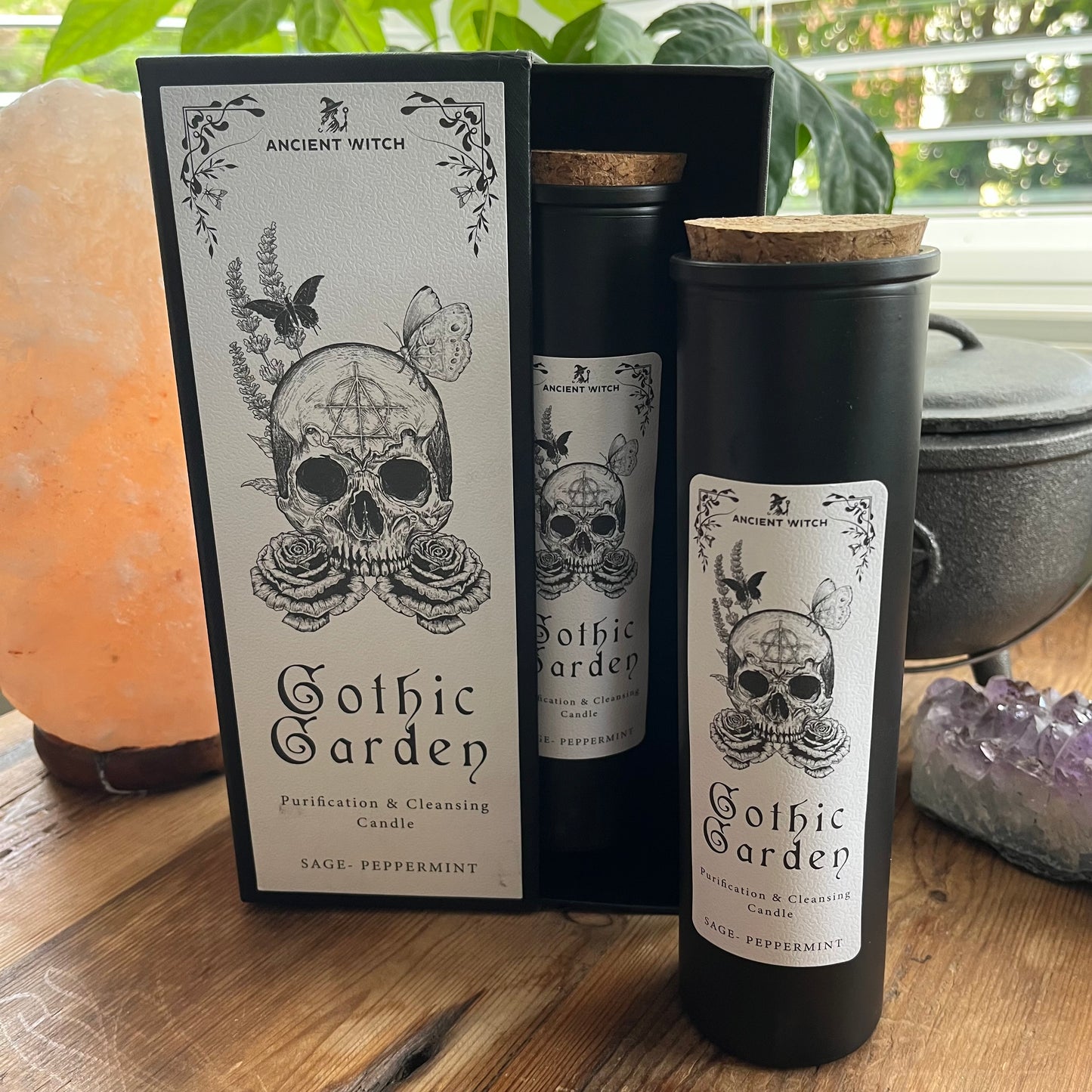 Ancient Witch Gothic Garden Candle with a beautifully illustrated gift box, illustrated with a skull & roses representing transformation. Each Glass pillar candle has a cork lid. Includes a ritual spell card.