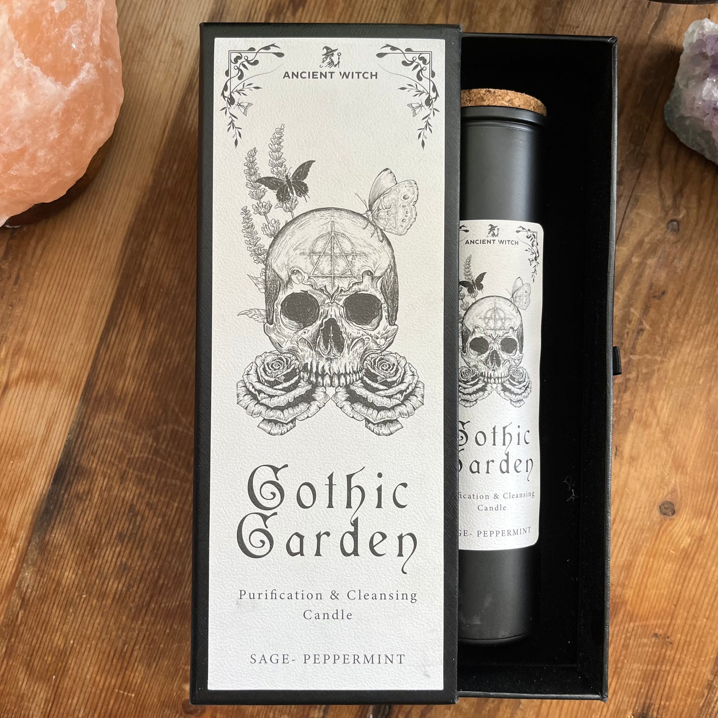 Ancient Witch Gothic Garden Candle with a beautifully illustrated gift box, illustrated with a skull & roses representing transformation. Each Glass pillar candle has a cork lid. Includes a ritual spell card.