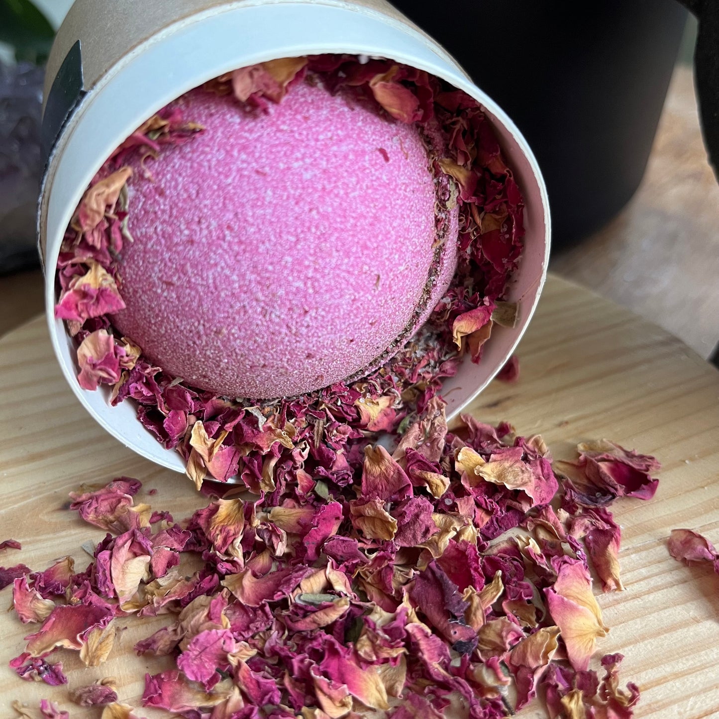 Pink Bath bomb pink rose petals pouring from it's round presentation box