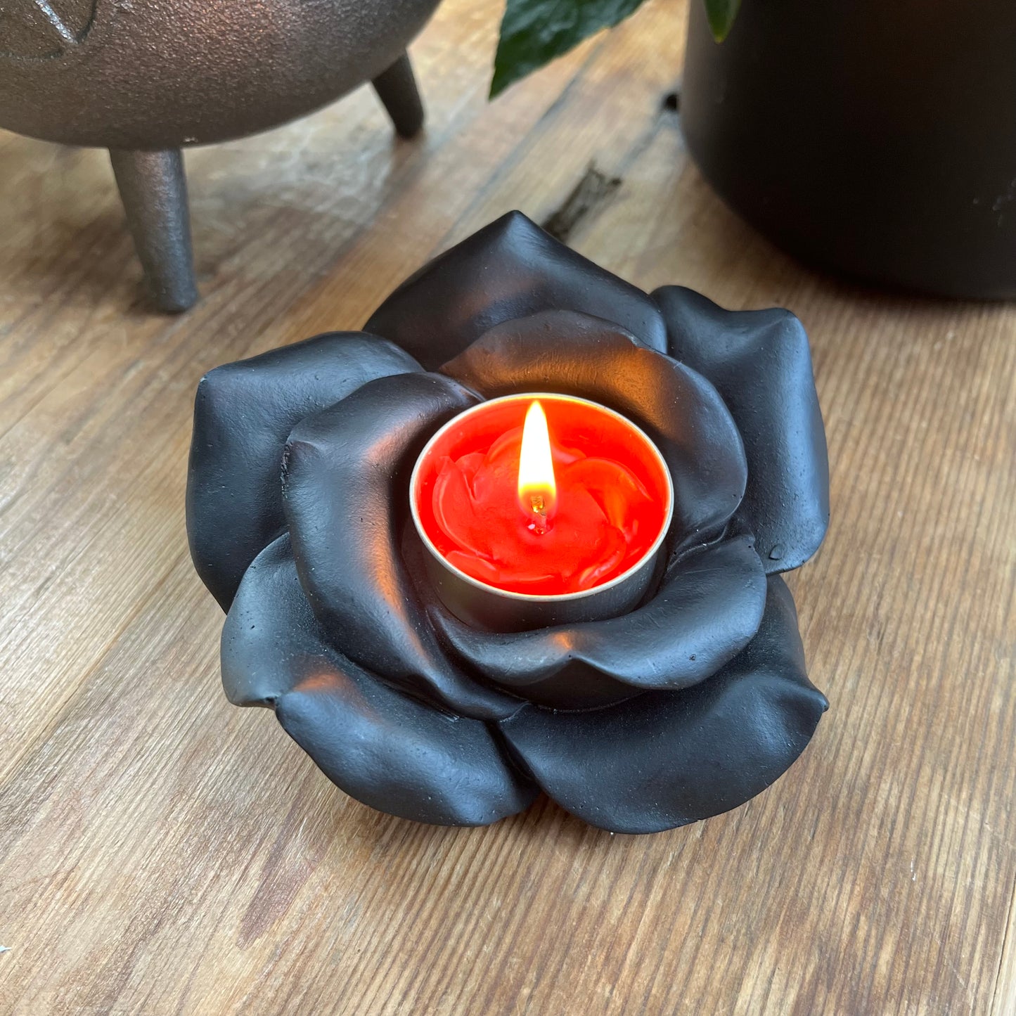 Black Rose Resin Tealight Candle Holder with a red tealight candle glowing