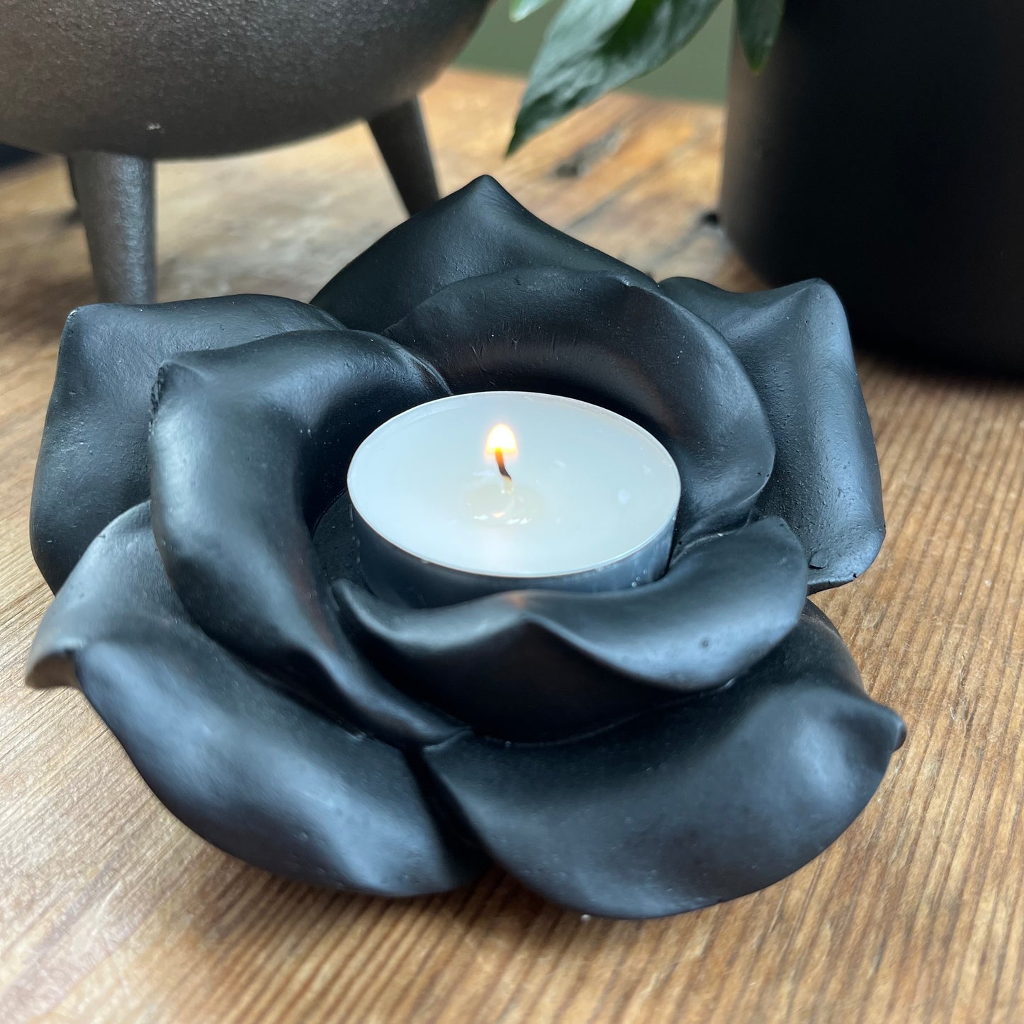 Black Rose Resin Tealight Candle Holder with a white tealight candle glowing