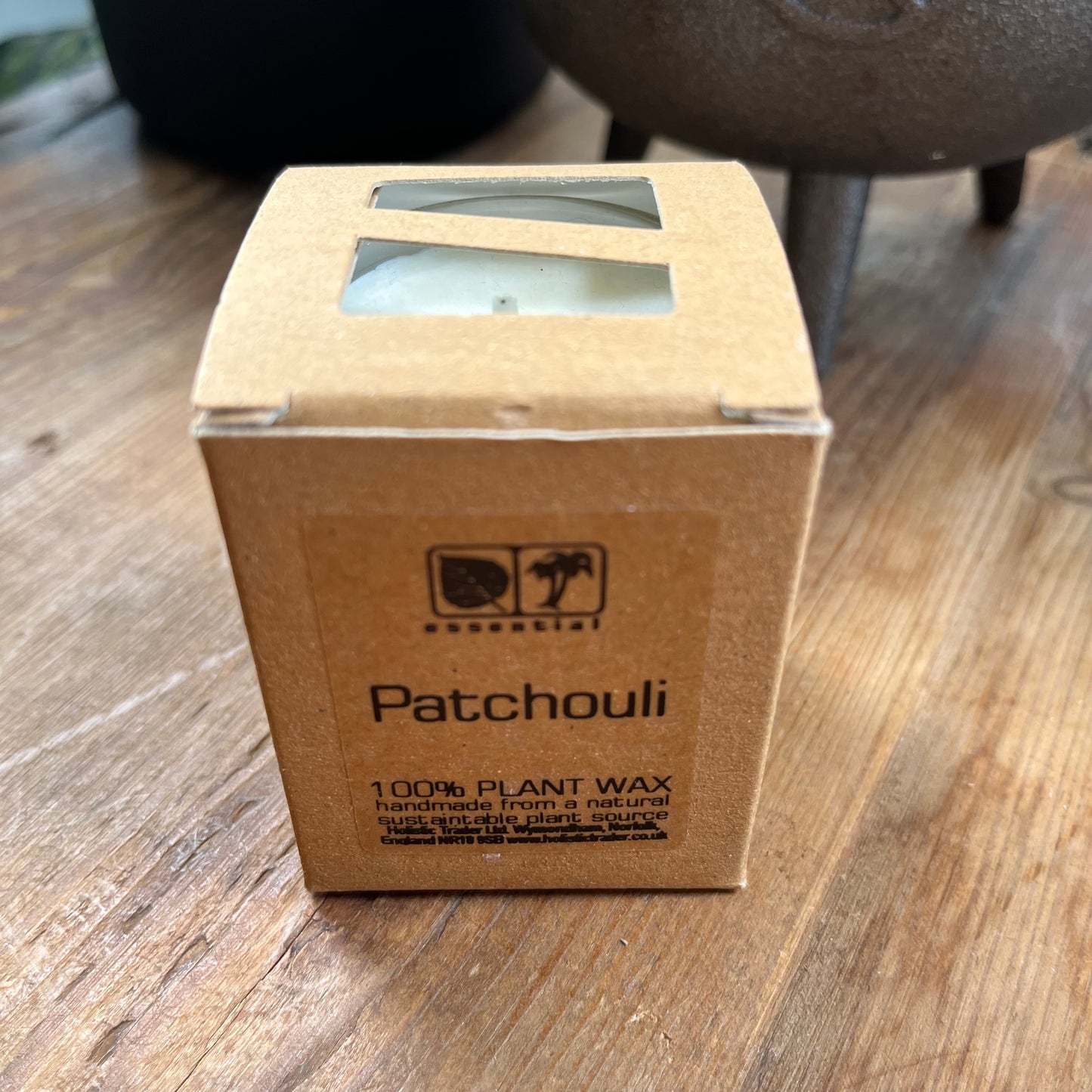 Boxed white votive candle in glass jar scented with patchouli essential oil