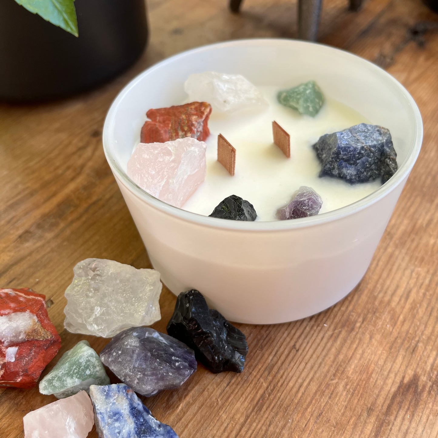 Large white candle with 7 large chunks of raw crystals to align with the 7 chakras