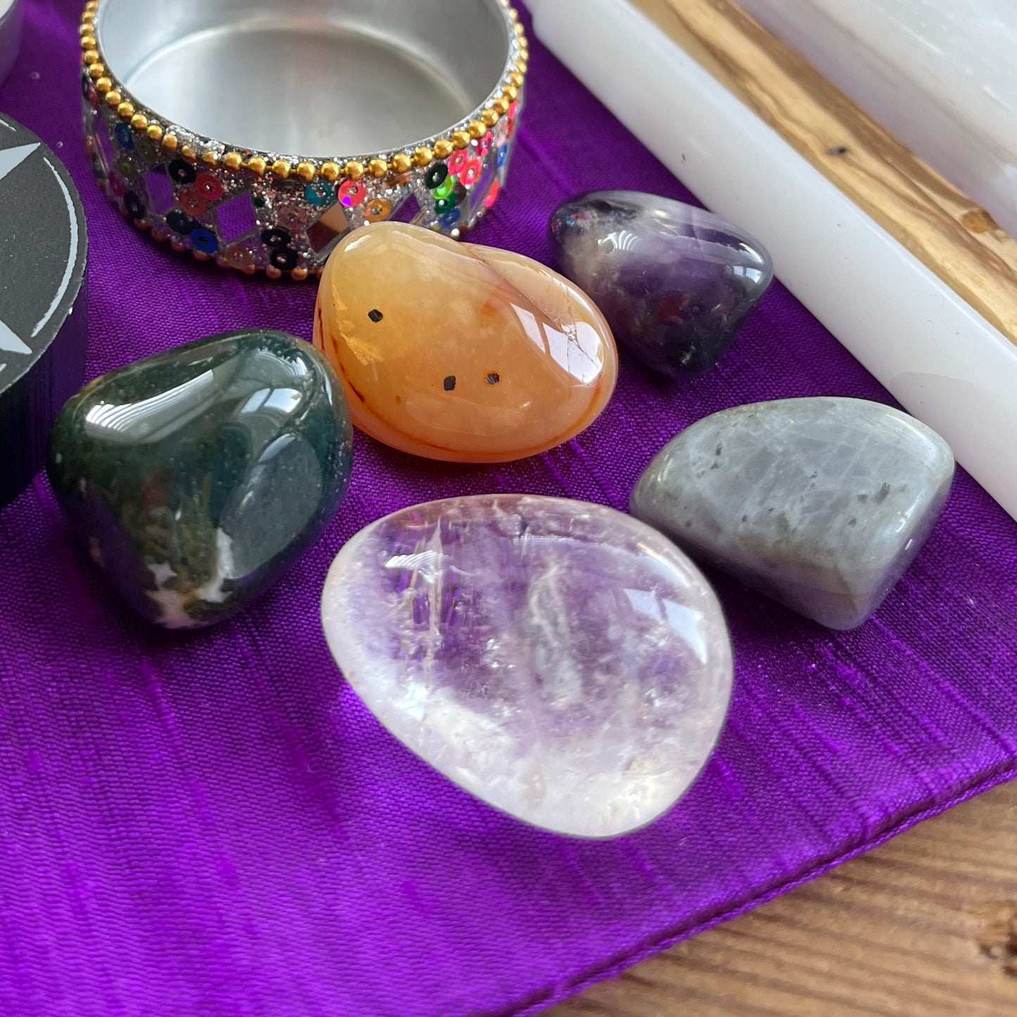Collection of polished stones on a purple cloth