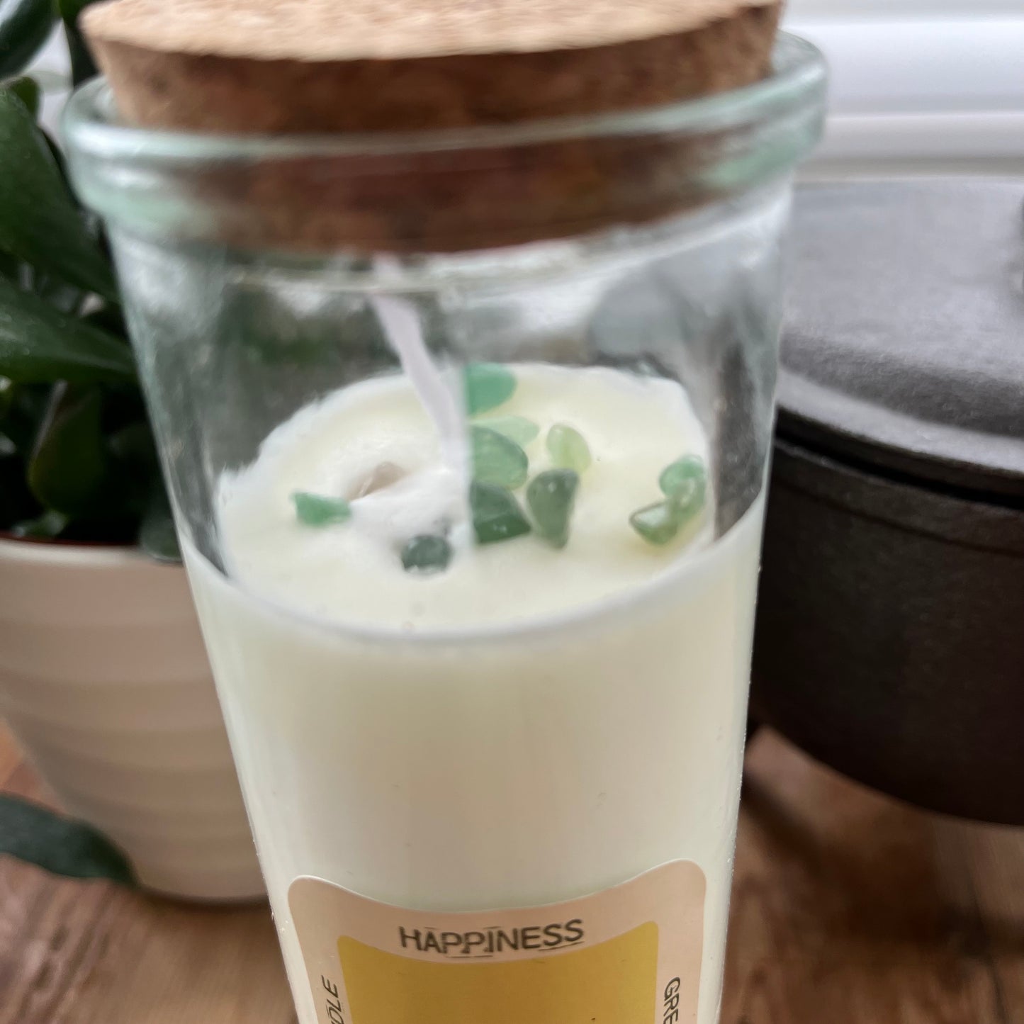 An overhead view of the Green Aventurine crystals embedded within the Happiness spell candle