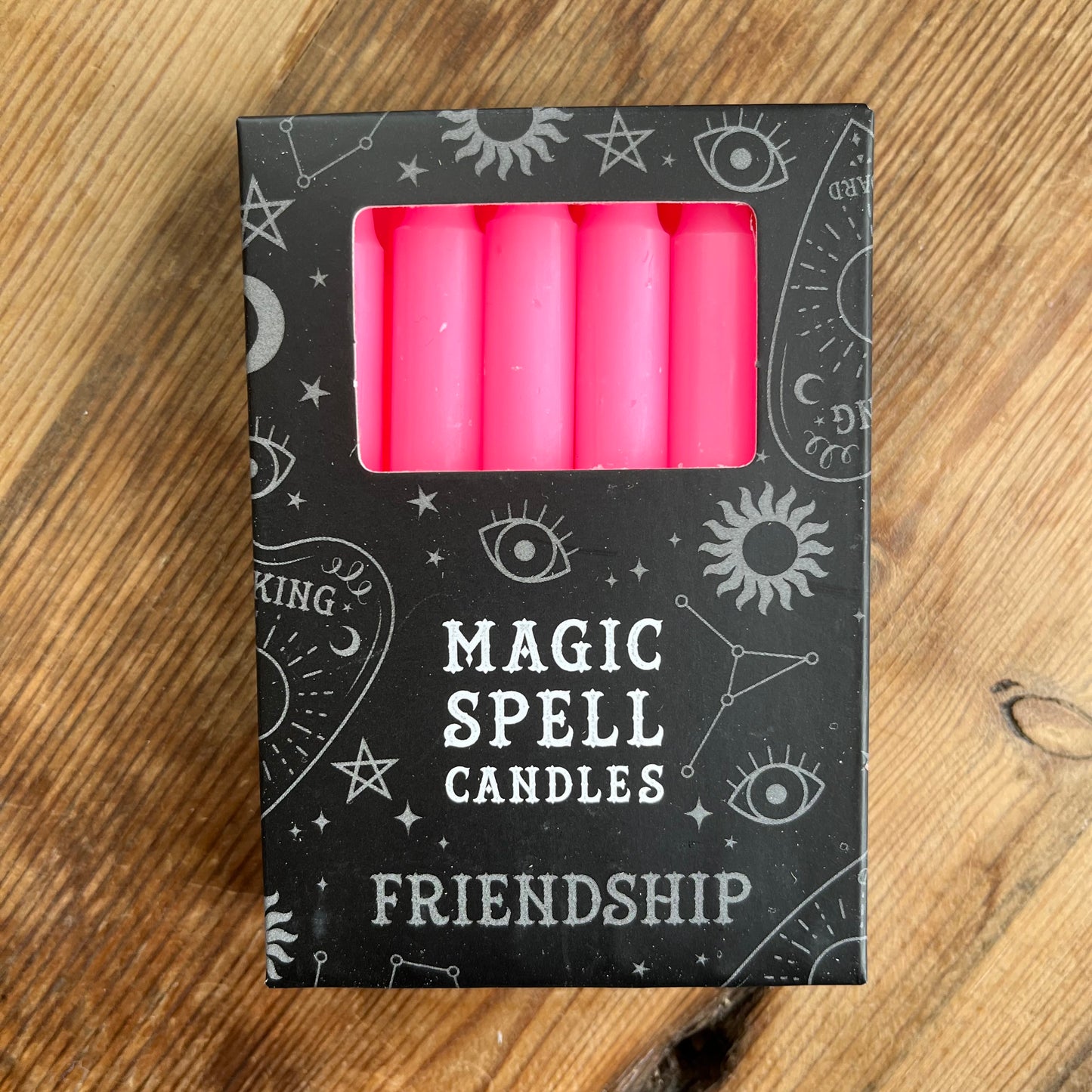Black Box containing 12 pink spell candles box reads magic spell candles for friendship