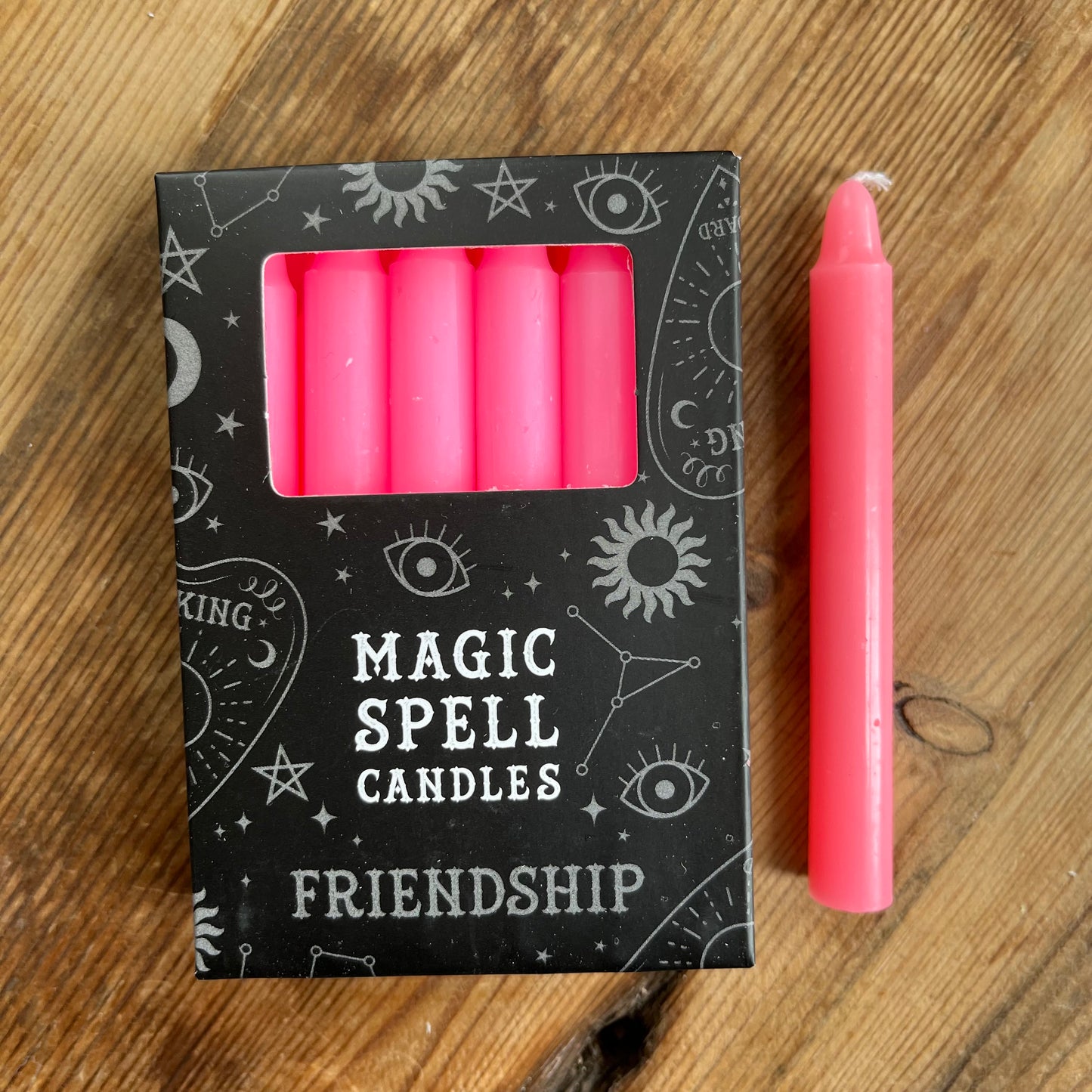 Black Box containing 12 pink spell candles box reads magic spell candles for friendship