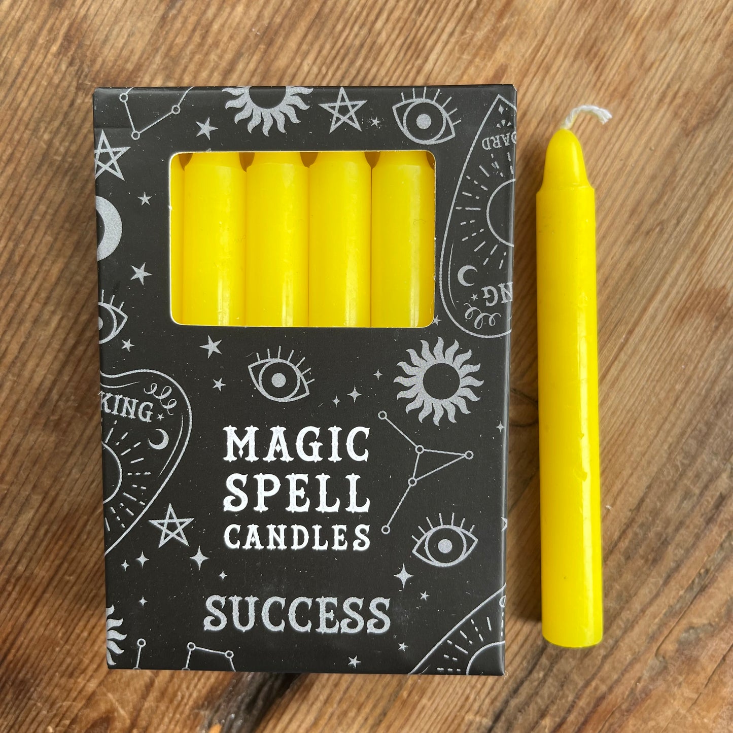 Black box containing 12 yellow spell candles the box reads magic spell candles for success