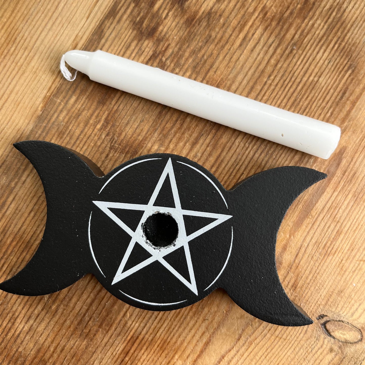 Black wooden spell candle holder in the shape of a triple moon with a Pentagram in white on its surface