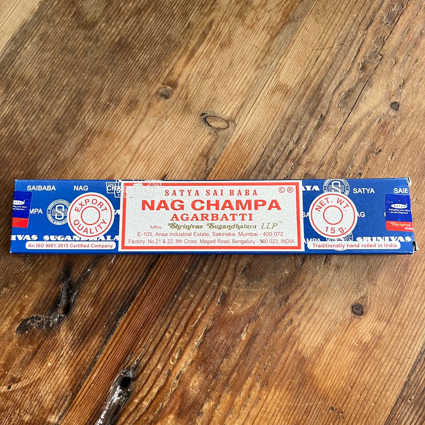 A box of Satya Sai Baba Nag Champa Agarbatti incense sticks displayed on a wooden surface.