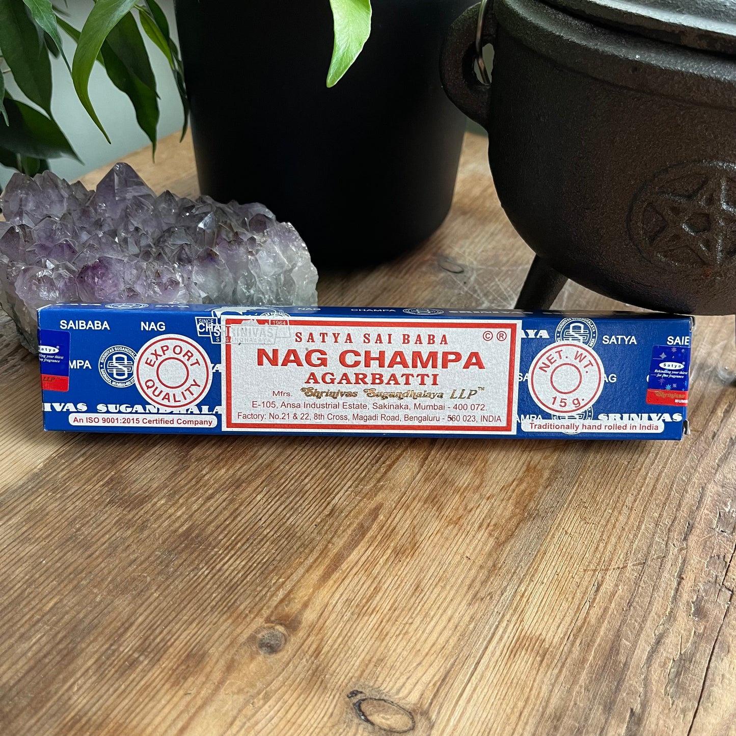 A box of Satya Sai Baba Nag Champa Agarbatti incense sticks displayed on a wooden surface.