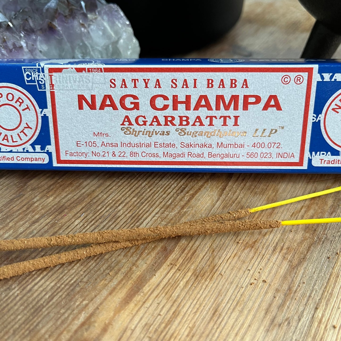 A box of Satya Sai Baba Nag Champa Agarbatti incense sticks displayed on a wooden surface.