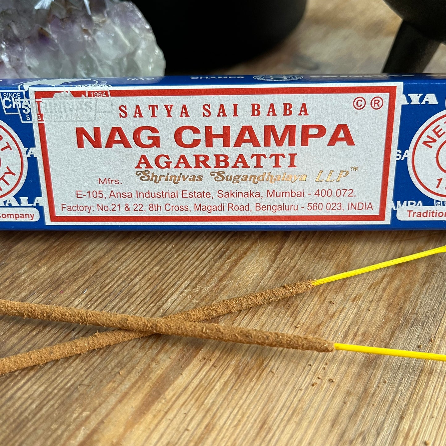 A box of Satya Sai Baba Nag Champa Agarbatti incense sticks displayed on a wooden surface.