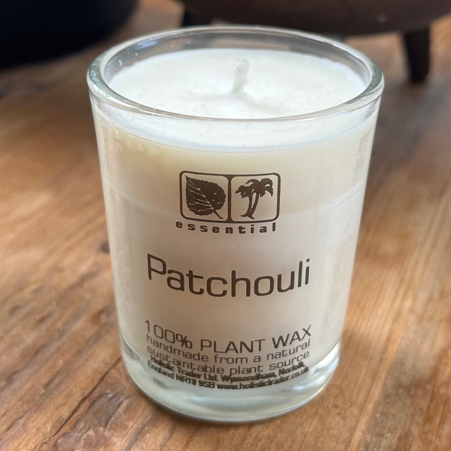 white votive candle in glass jar scented with patchouli essential oil