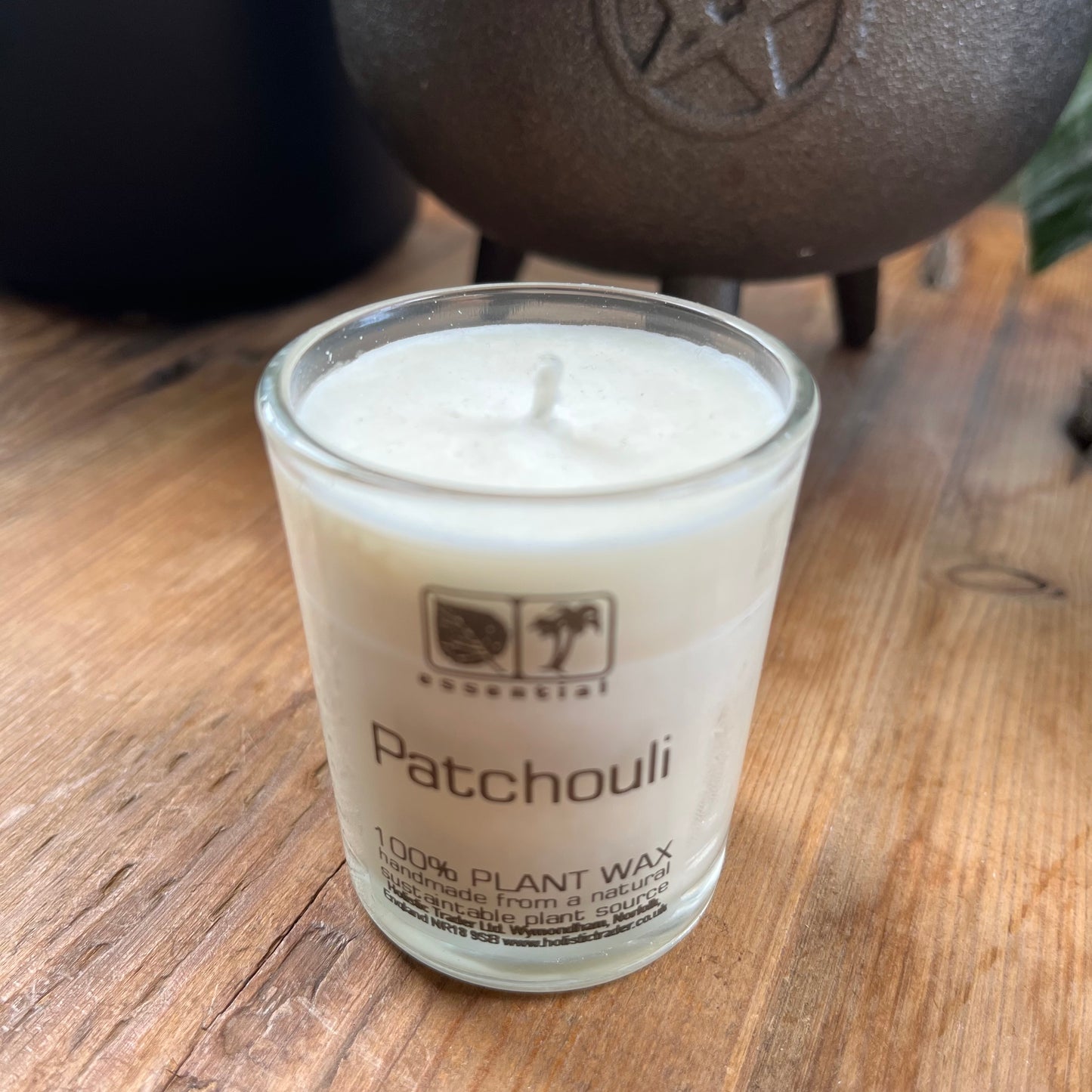 white votive candle in glass jar scented with patchouli essential oil