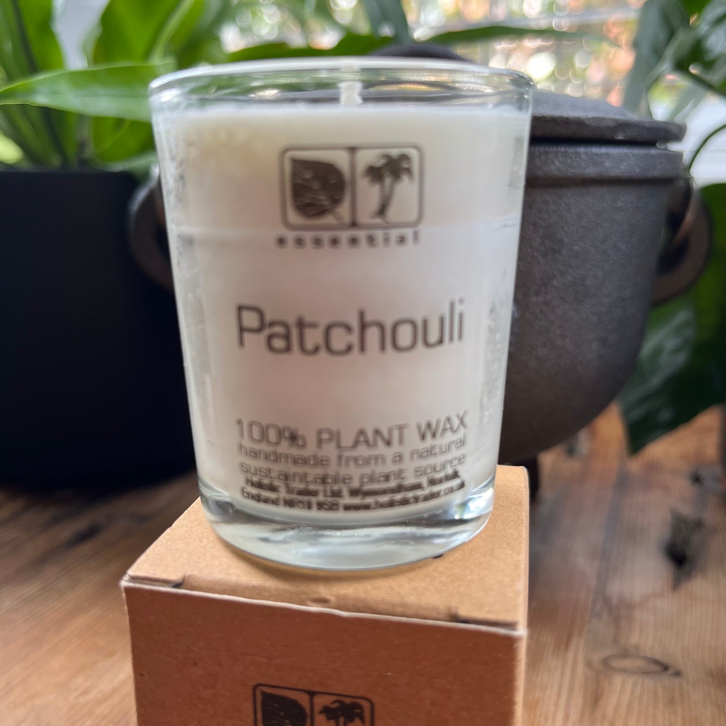 white votive candle in glass jar scented with patchouli essential oil