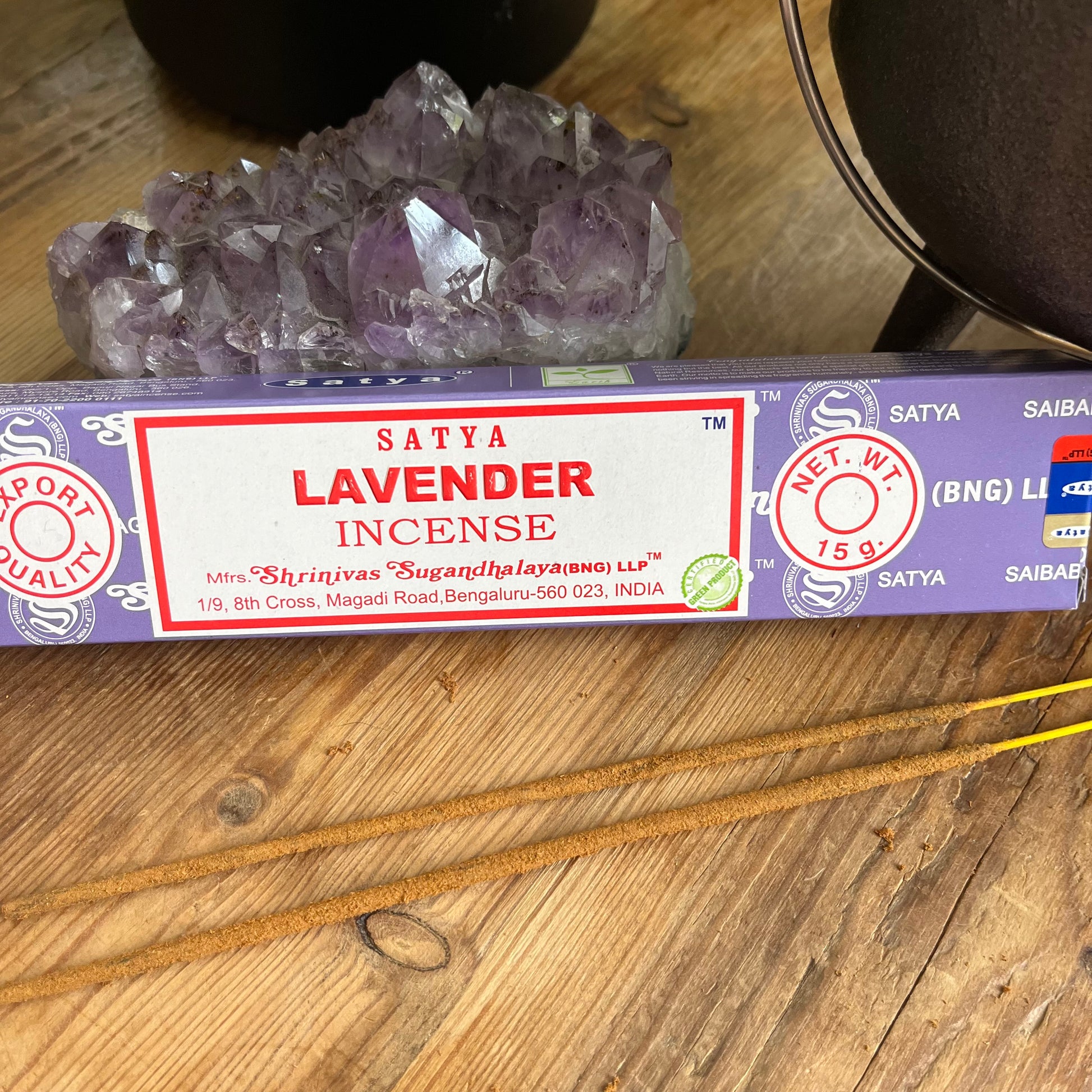 Satya Lavender incense packaging on a wooden surface with crystals in the background