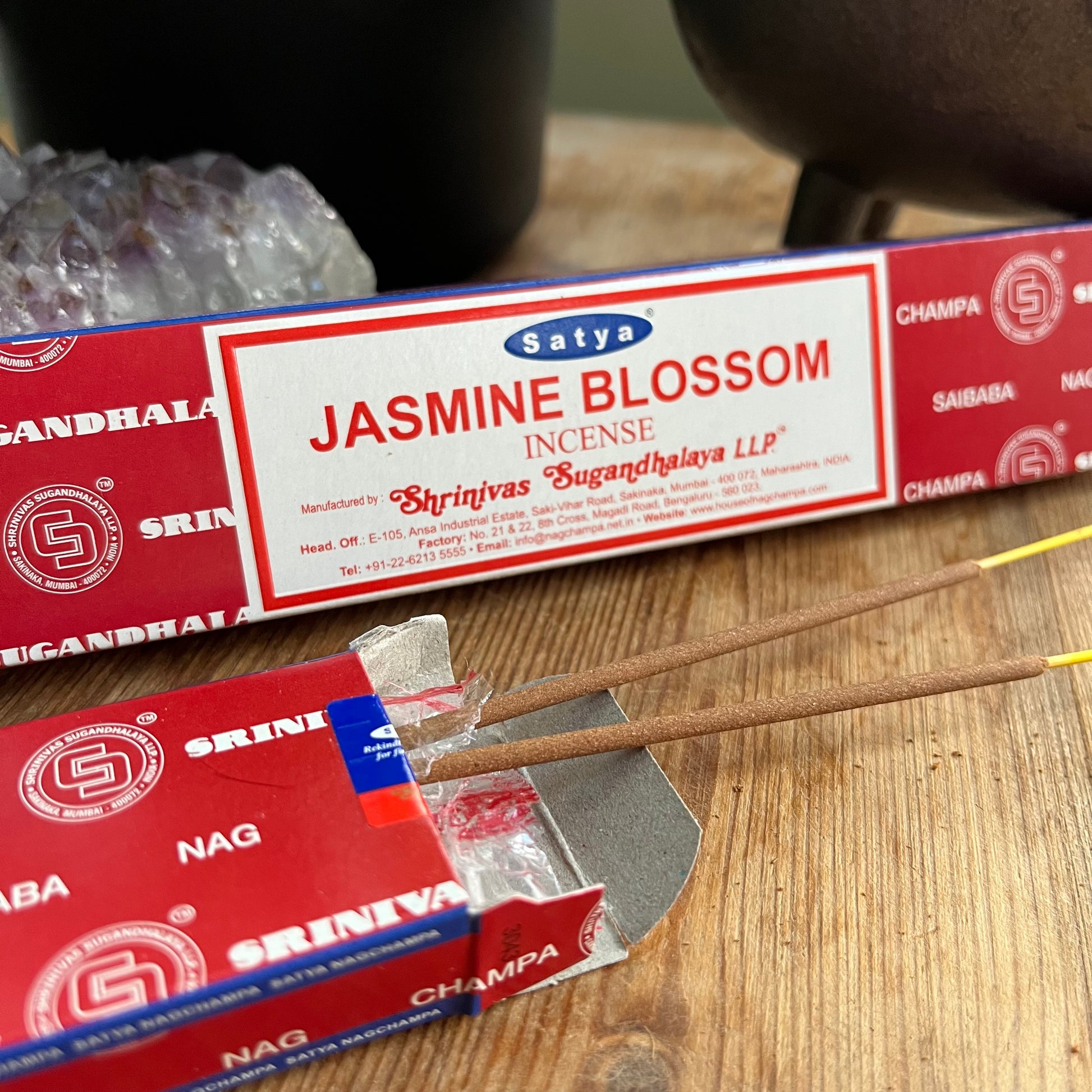 A box of Satya Jasmine Blossom incense on a wooden surface.