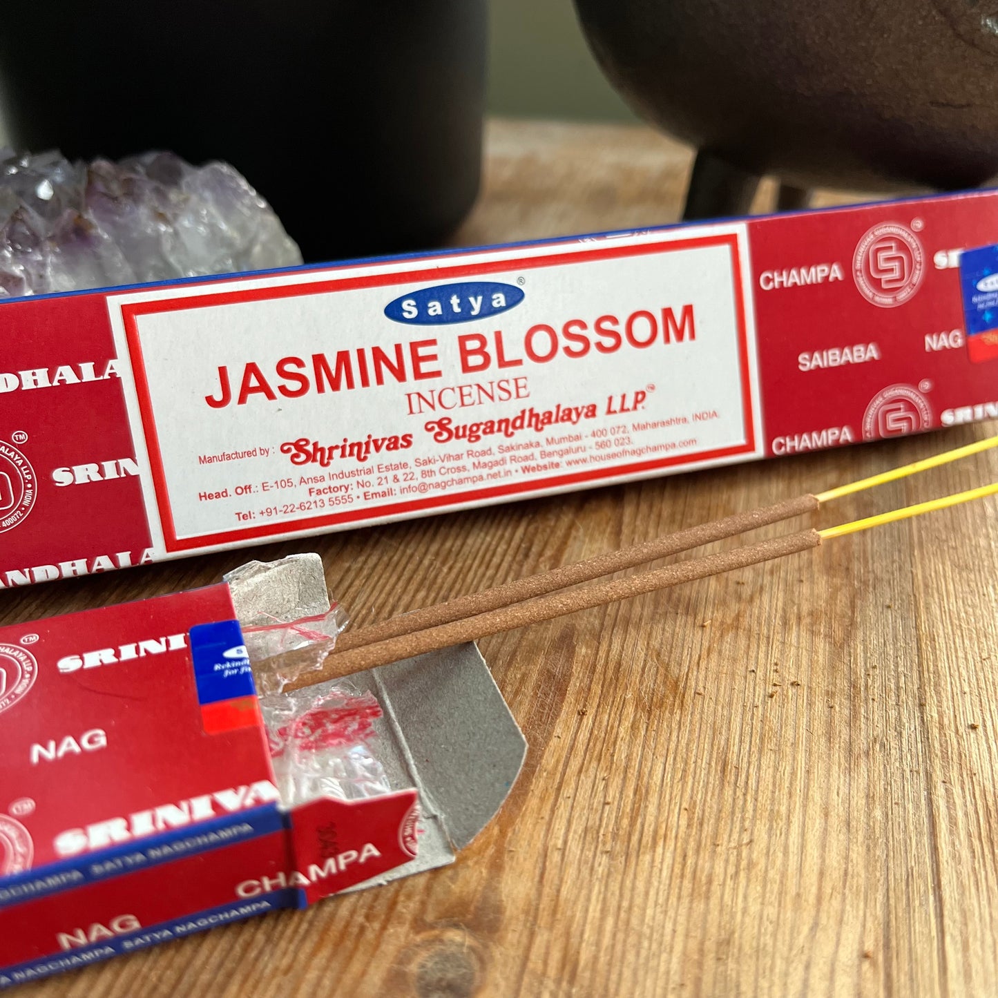 A box of Satya Jasmine Blossom incense on a wooden surface.