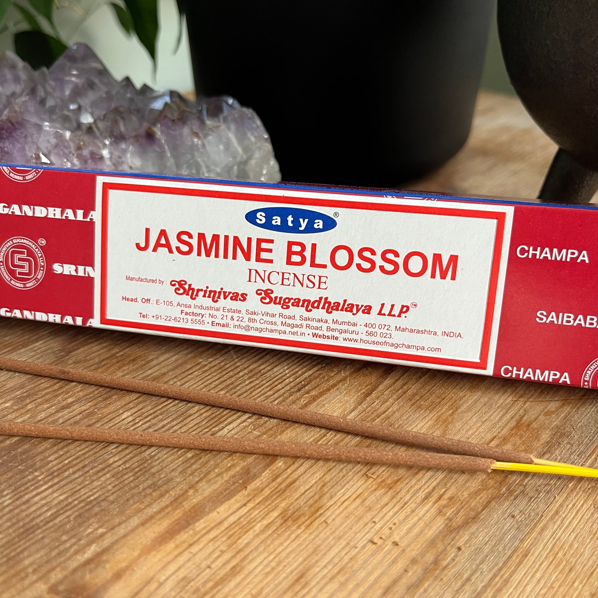 A box of Satya Jasmine Blossom incense on a wooden surface.