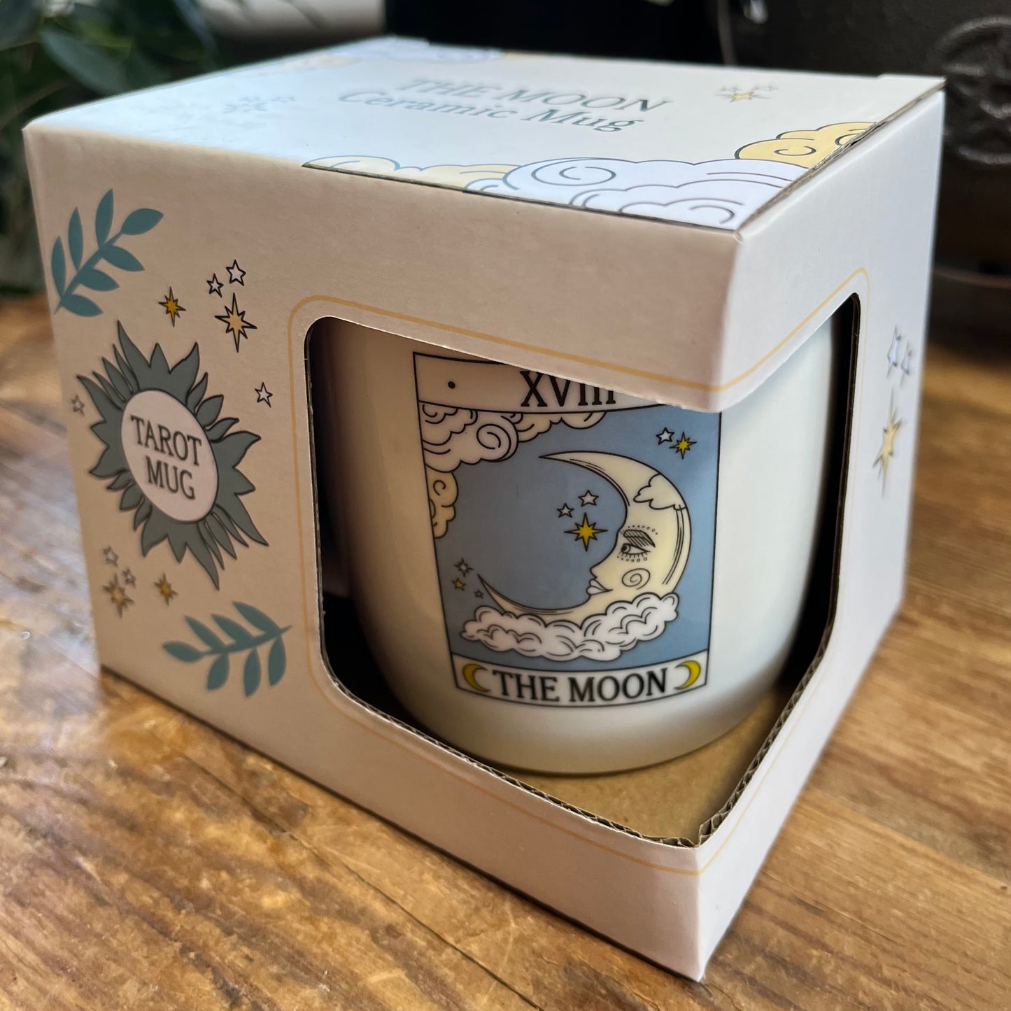 Mug with 'The Moon' design in a box on a wooden surface