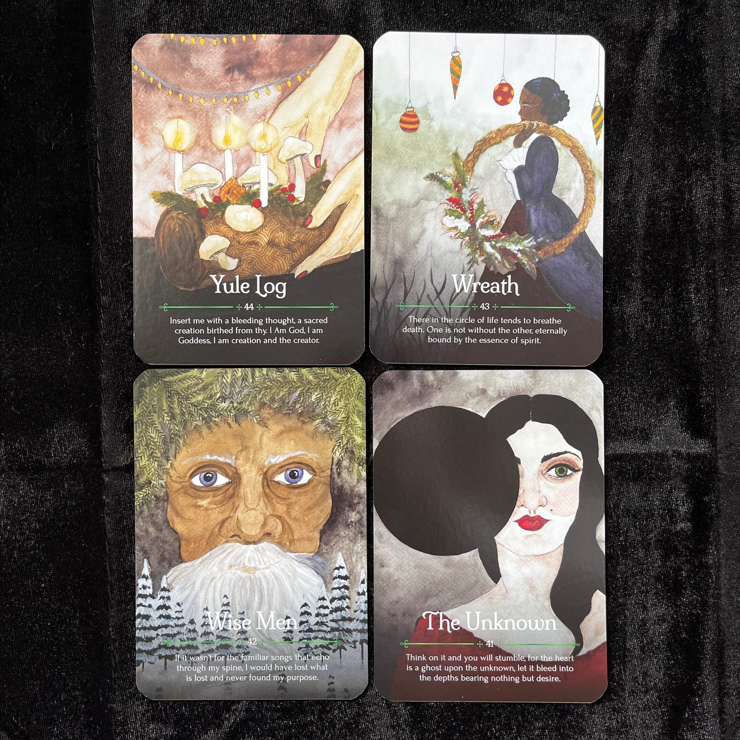 Four tarot cards with illustrations and text on a dark background