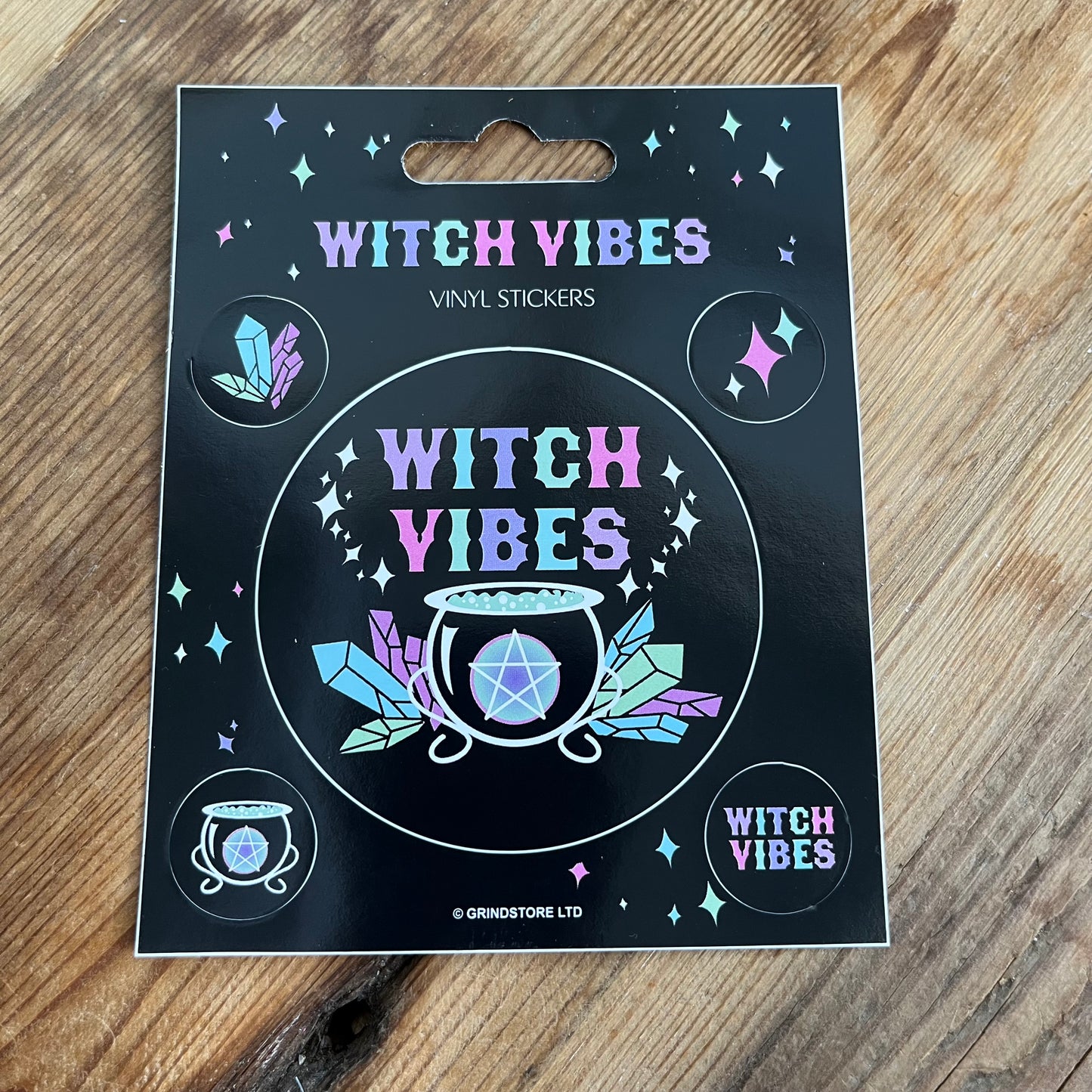 1 Large sticker and 4 smaller stickers. with the words witchy vibes and witchcraft symbols of cauldron, crytals and the words witchy vibes in bright colours.