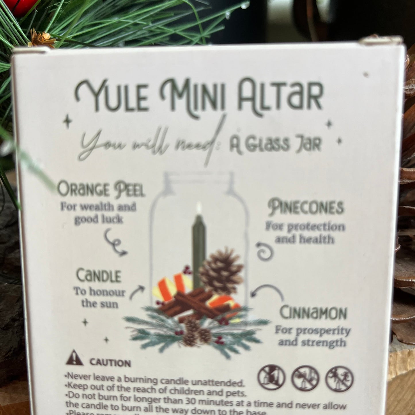 Back of the winter rital candles, shown instructions for creating a mini yule altar in a glass jar