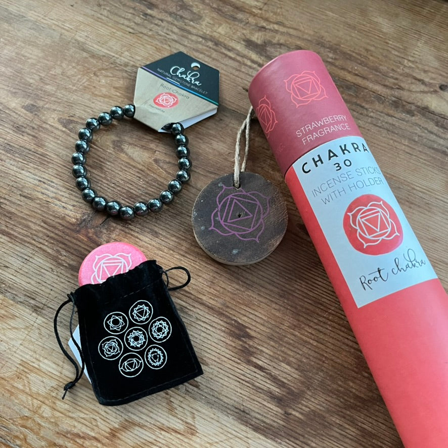 Chakra incense set with bracelet, bag, and labels on a wooden surface