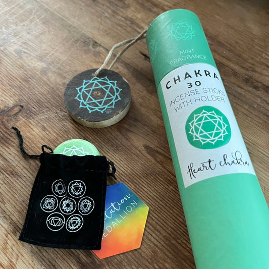 Chakra themed incense stick set with packaging on a wooden surface