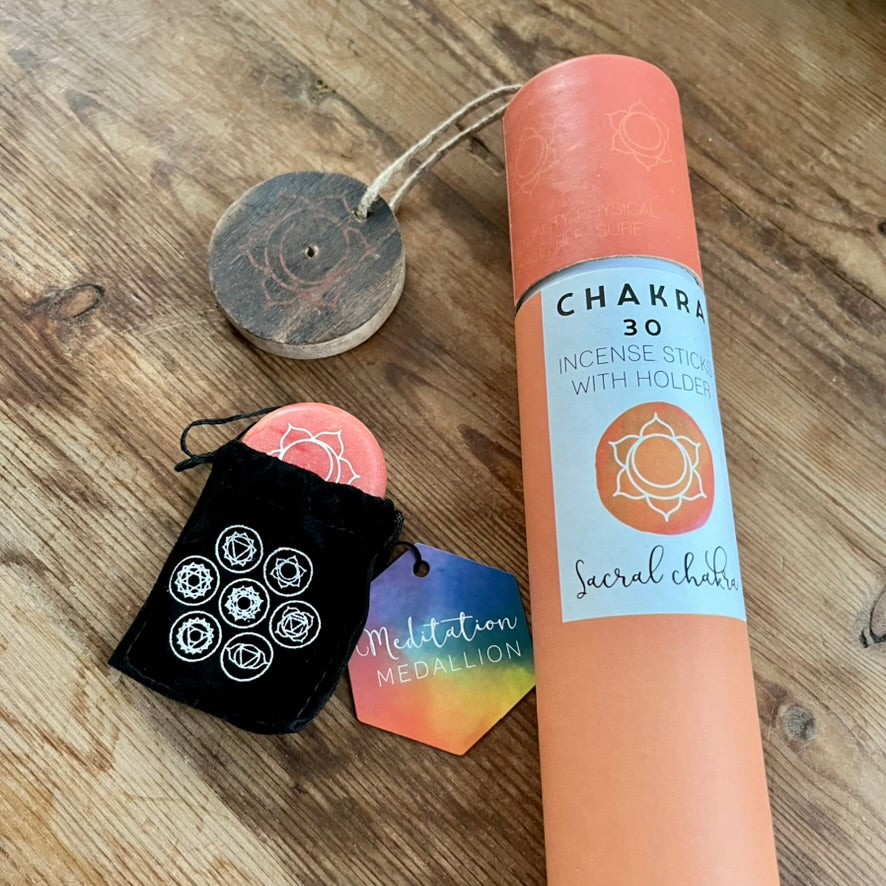 Chakra incense stick set with packaging on a wooden surface