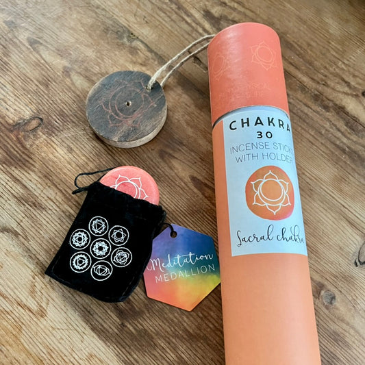 Chakra incense stick set with packaging on a wooden surface