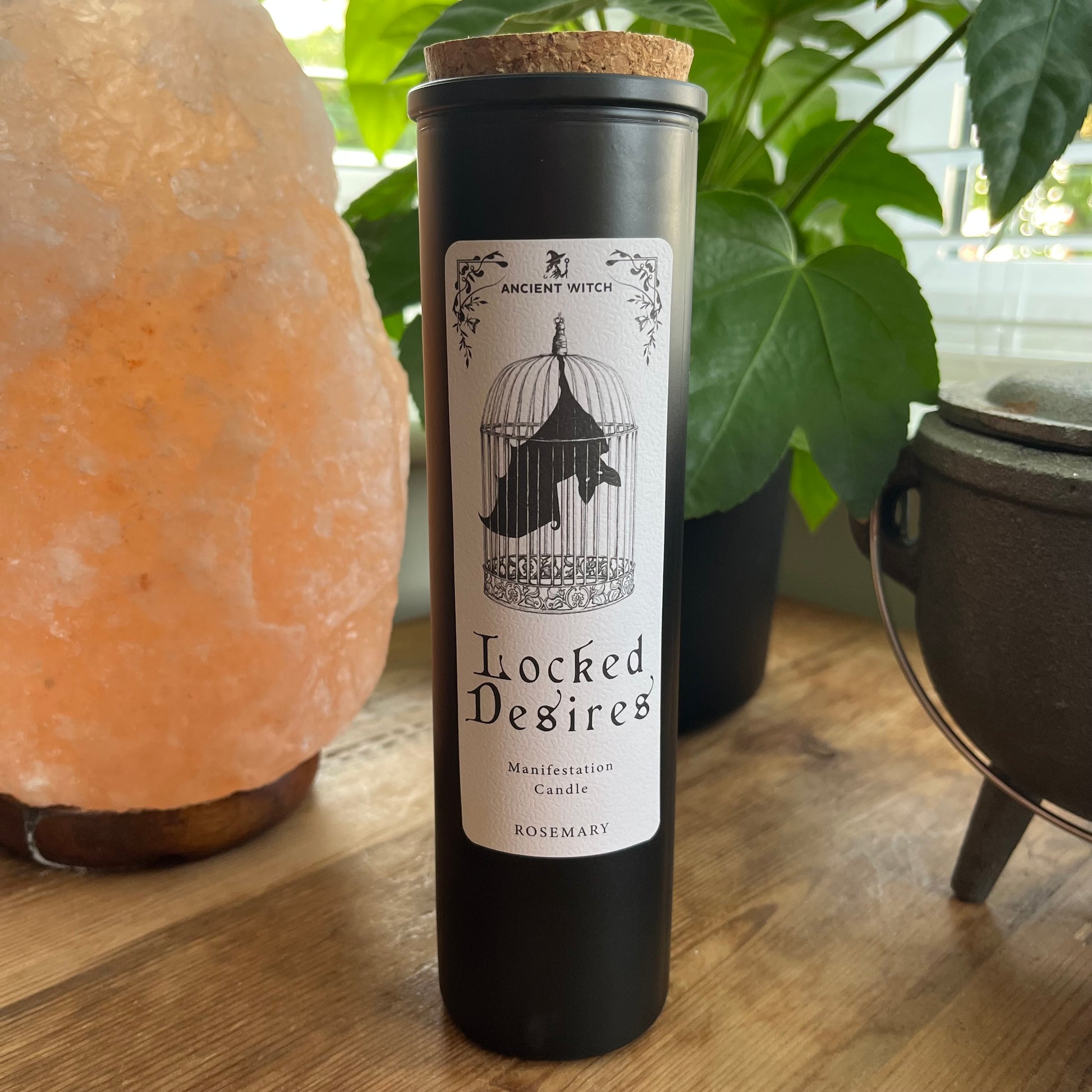 Ancient Witch Locked Desires candle in a beautifully illustrated gift box, illustrated with a Bat in a cage representing suppressed dreams, inner power and courage.  Each Glass pillar candle has a cork lid. Includes a ritual spell card. 
