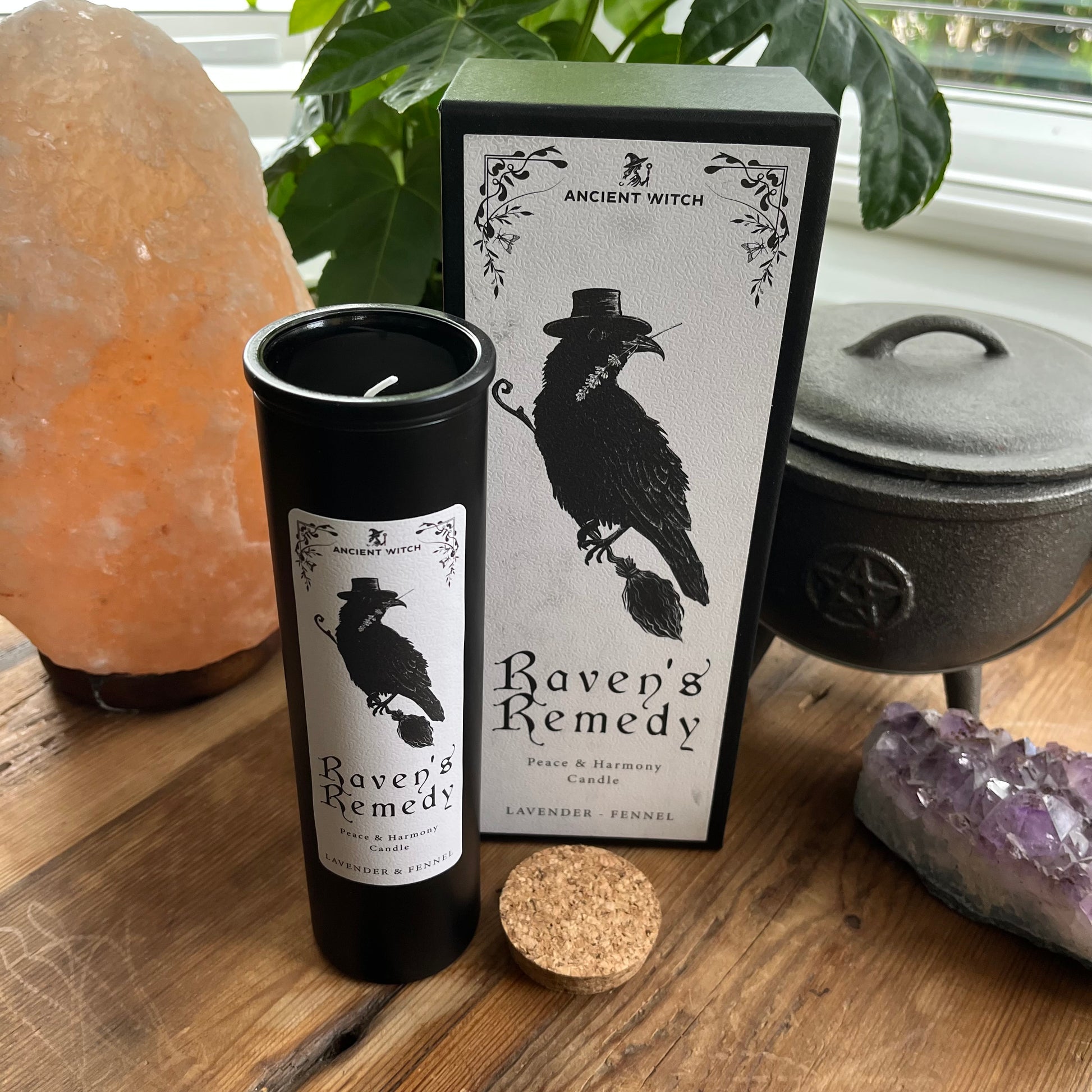 Ancient Witch Ravens Remedy candle in a beautifully illustrated gift box, illustrated with a Raven representing transformation, intuition, and protection.  Each Glass pillar candle has a cork lid. Includes a ritual spell card. 