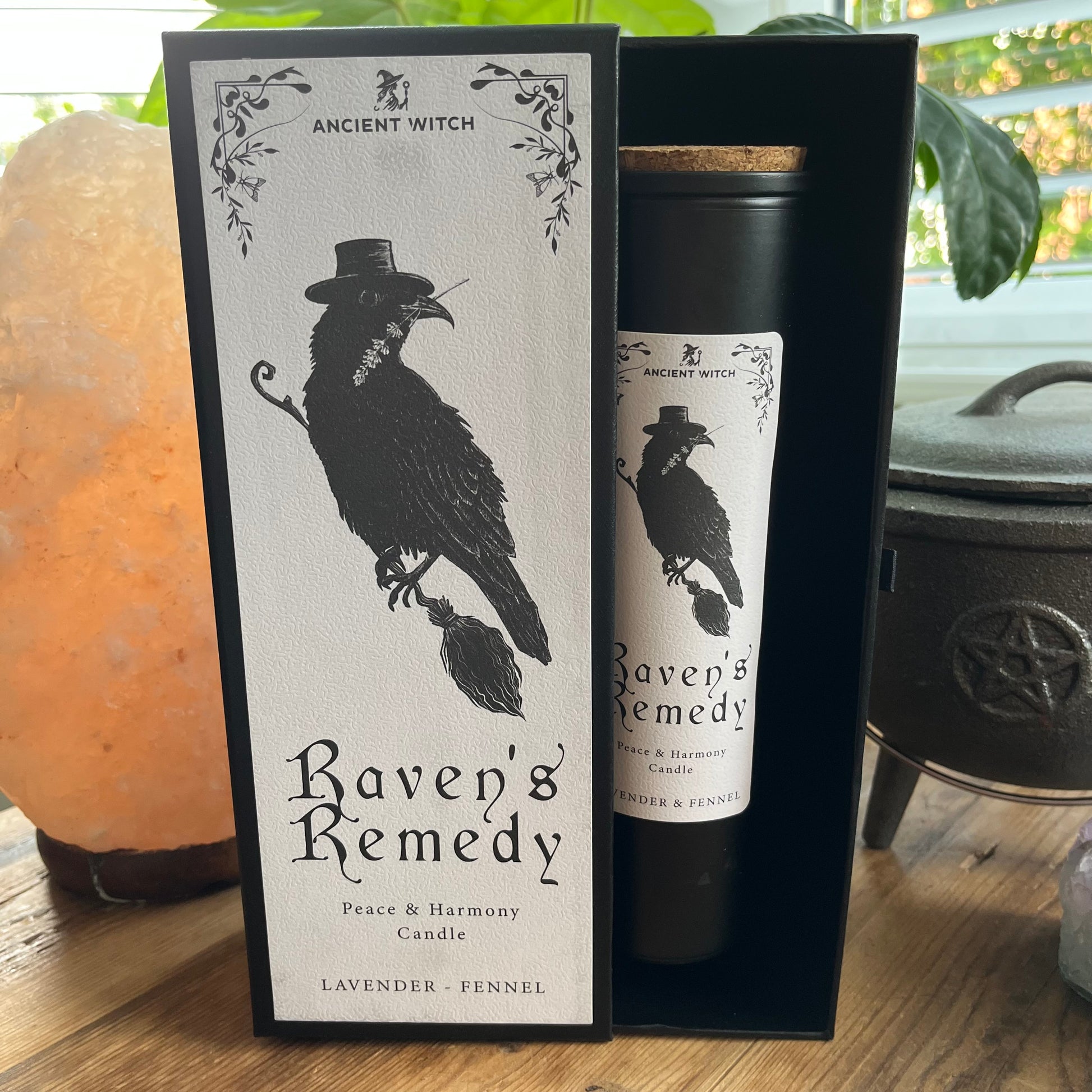 Ancient Witch Ravens Remedy candle in a beautifully illustrated gift box, illustrated with a Raven representing transformation, intuition, and protection.  Each Glass pillar candle has a cork lid. Includes a ritual spell card. 
