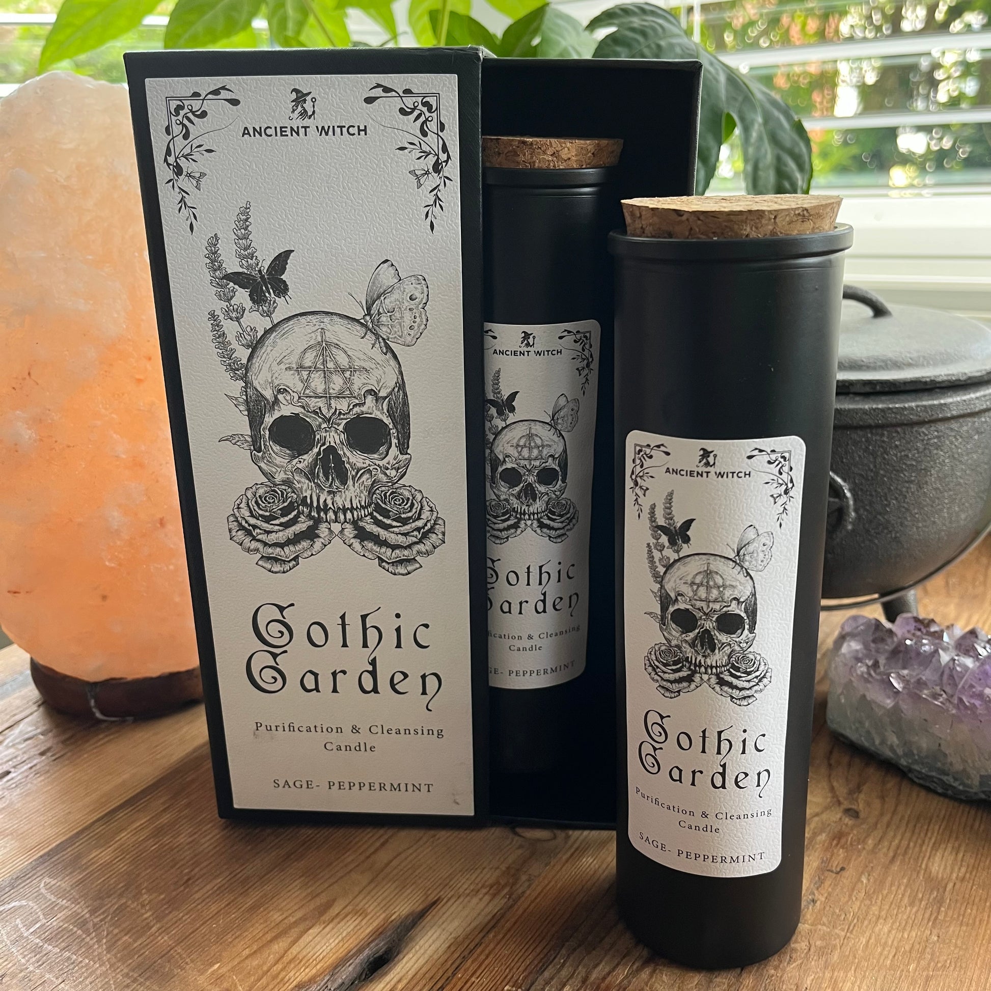 Ancient Witch Gothic Garden Candle with a beautifully illustrated gift box, illustrated with a skull & roses representing transformation.  Each Glass pillar candle has a cork lid. Includes a ritual spell card. 