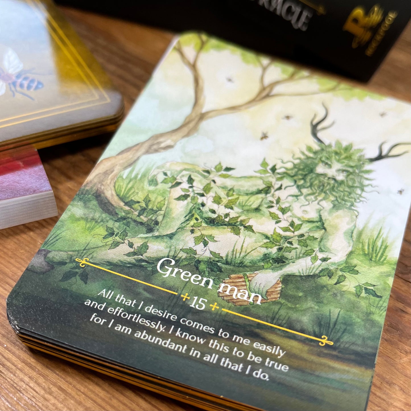 Card with green man illustration and text on a wooden surface