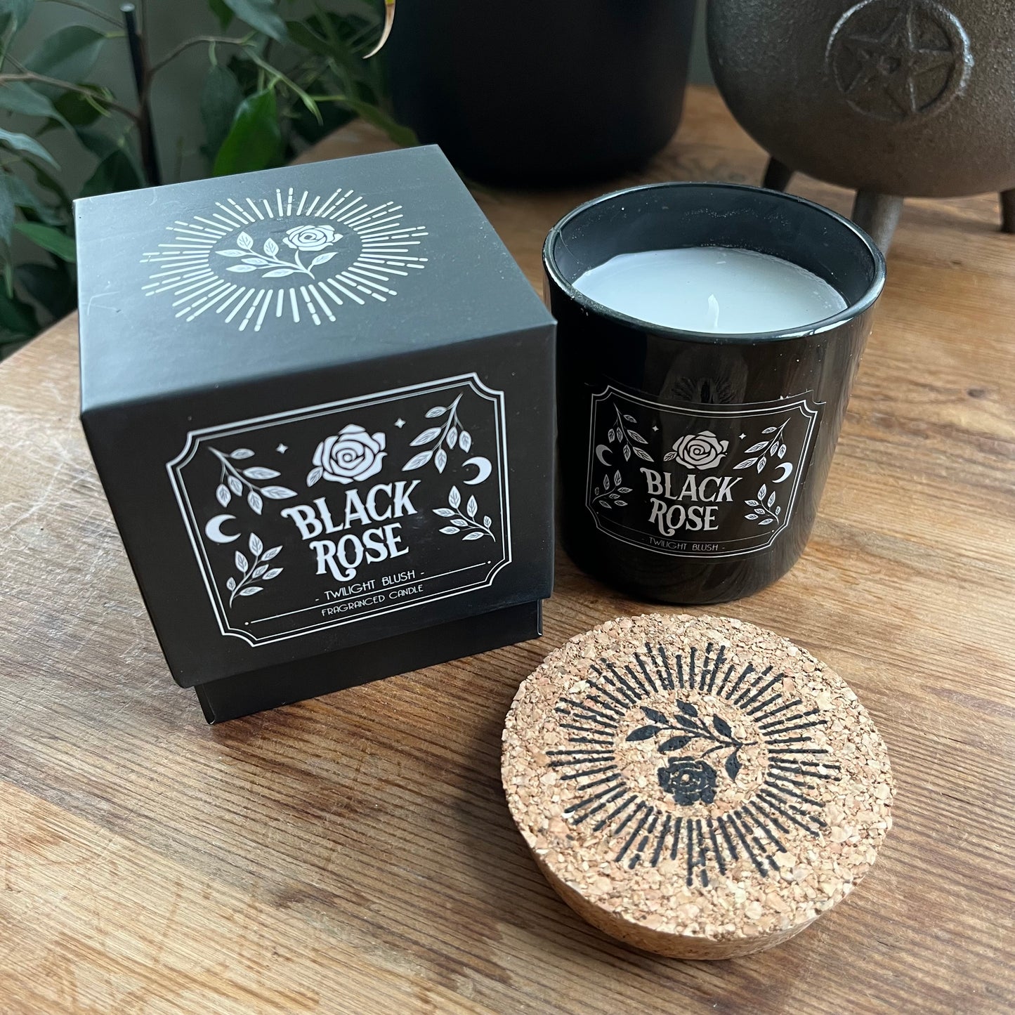 Black Rose candle with a matching sliding box on a wooden surface