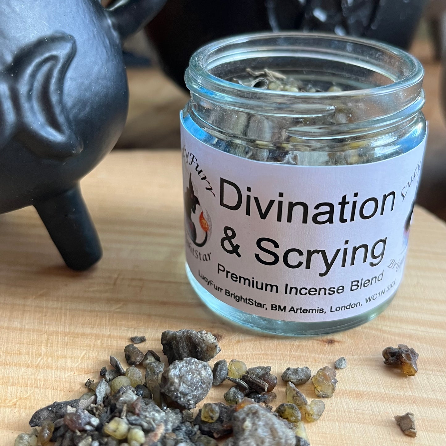 Jar of 'Divination & Scrying' premium incense blend with incense crystals on a wooden surface.