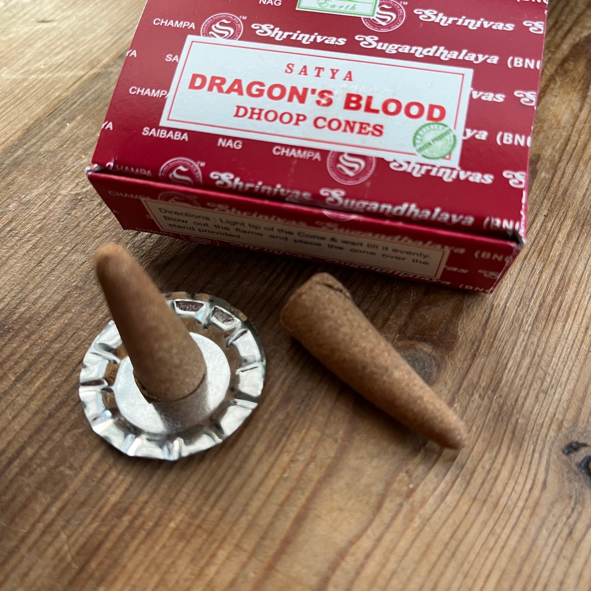 Box of Satya Dragons blood incense cones on wooden surface