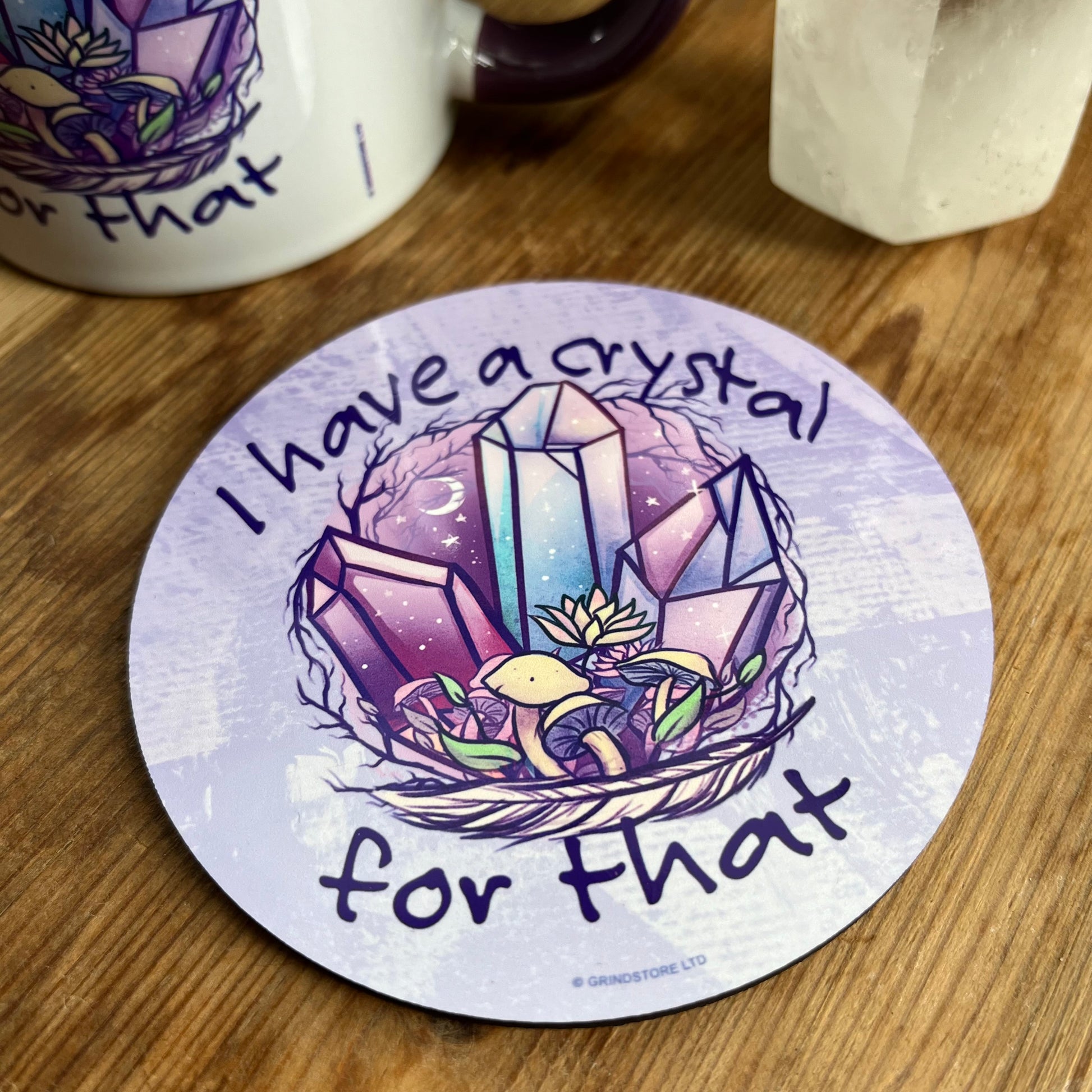 Purple coaster with an illustration of crystals and the words 'i have a crystal for that' 