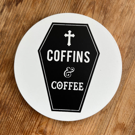 White Coaster featuring a Gothic Black coffin image and the words Coffins and coffee in bold white text