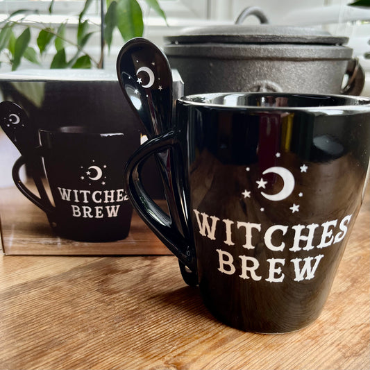 Boxed Black mug with the words Witches brew and a moon and star design in white. A matching spoon slots into the handle