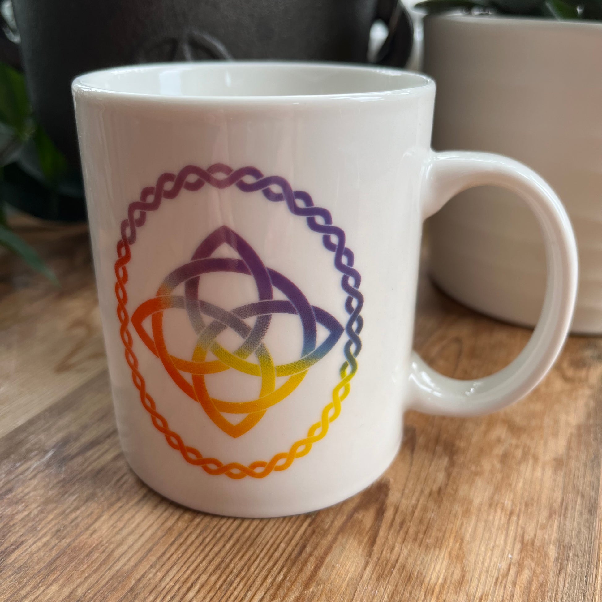 White mug with a Celtic Knot design on  both sides. 